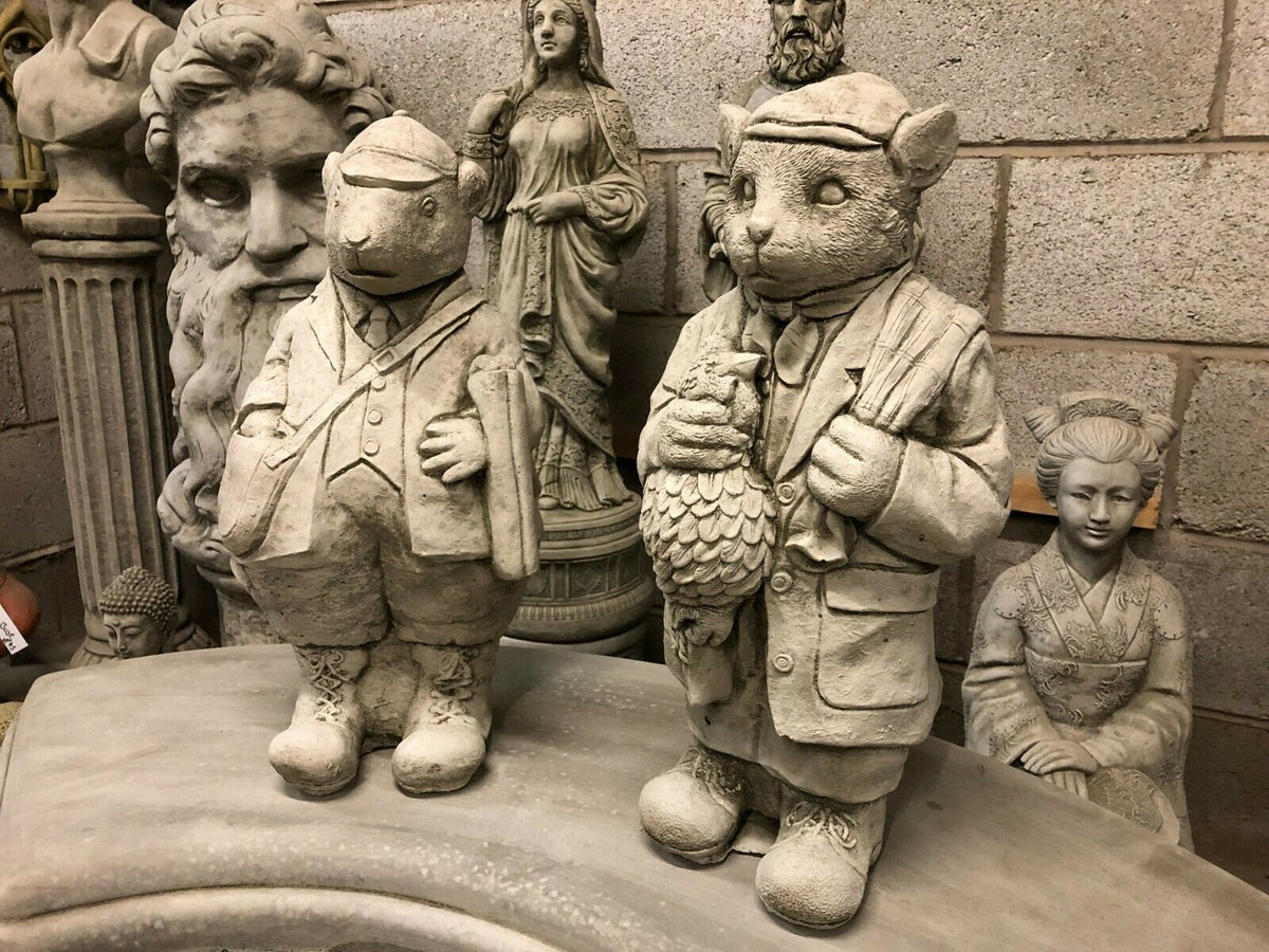 Stone Gamekeeper & Poacher Statues-Garden Decor | Solid & Durable. Pair of animal-themed limestone garden statues in vintage attire, ideal for outdoor decor.