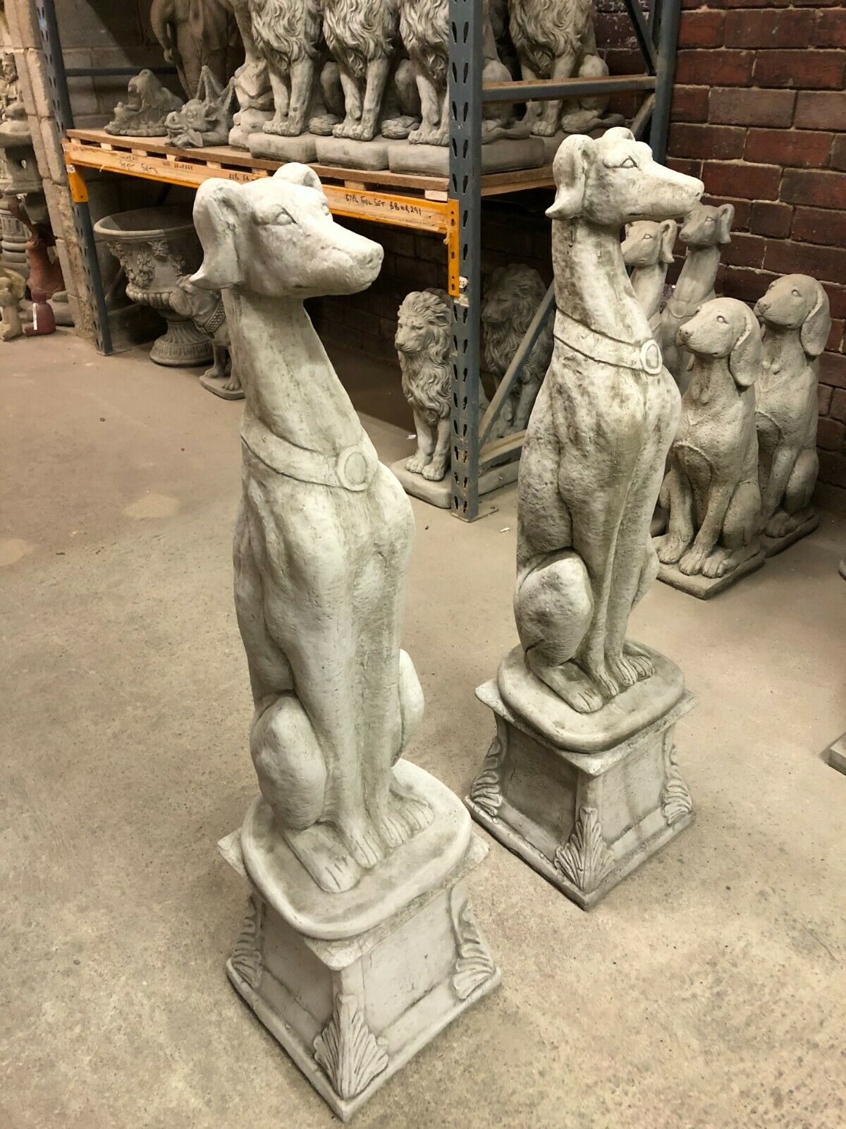 Pair of Elegant Stone Greyhound Dog Garden Statues featuring detailed craftsmanship and limestone finish, perfect for garden entrances or flowerbeds.