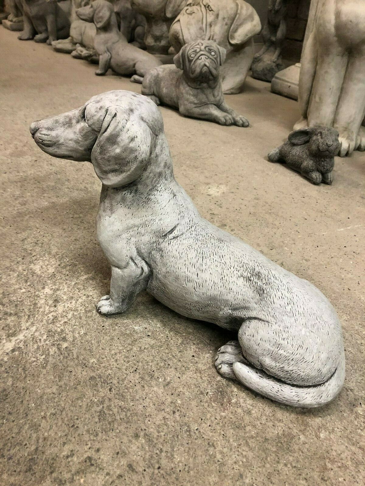 Stone Sausage Dog Ornament in antique finish, side view showing detailed texture and weatherproof design for garden decor.