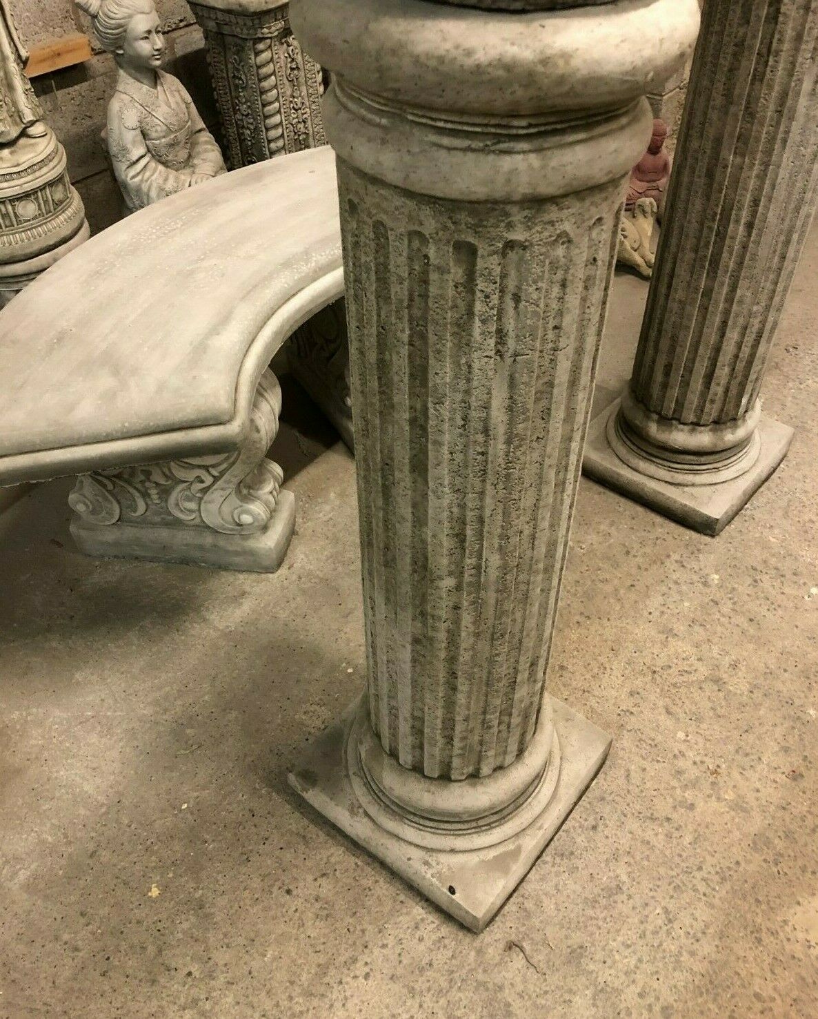 Angled view of Roman Garden Column Plinths with antique grey finish, perfect for supporting statues in patios or landscaped gardens.