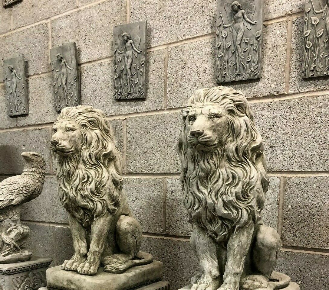 Pair of majestic stone lion statues on square plinths, perfect for enhancing garden aesthetics with a classic and elegant touch.