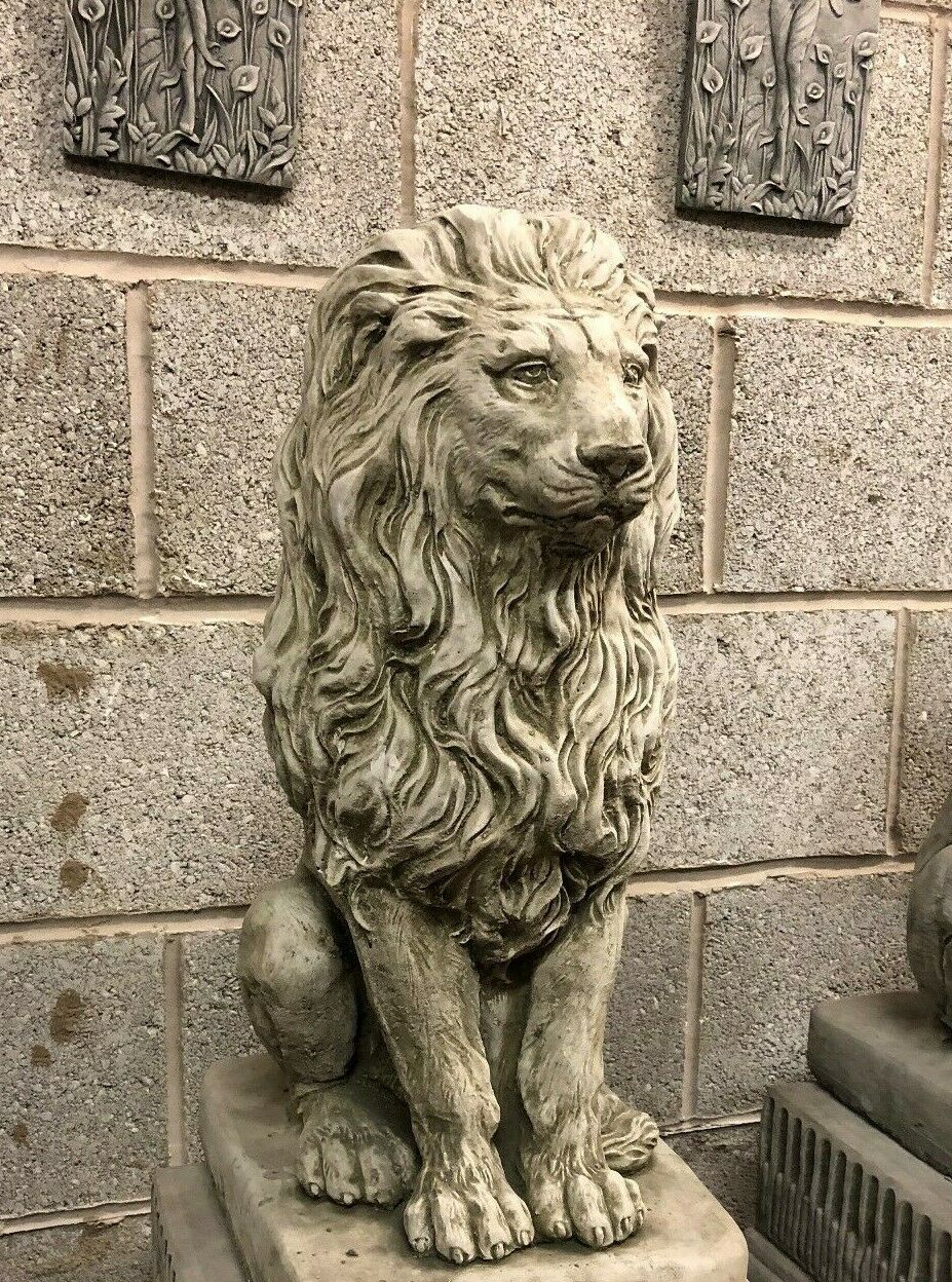 Angled view of a stone lion garden statue with a regal pose and textured finish, ideal for patios or lawn ornamentation.