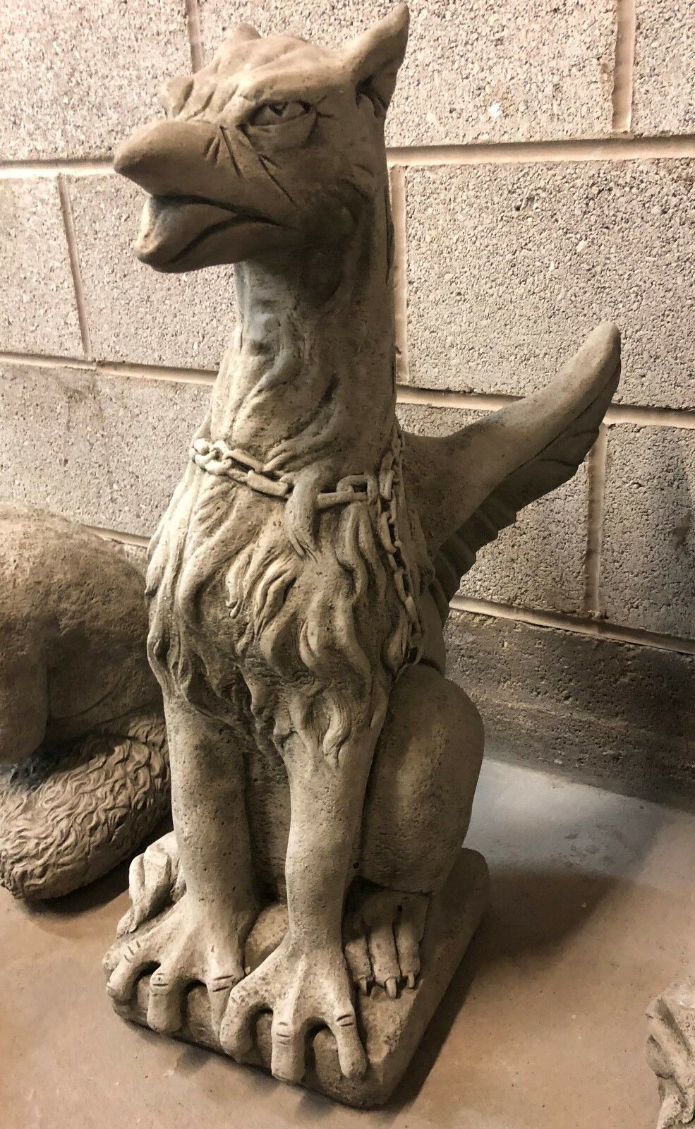 Limestone phoenix statue with antique grey finish and chained neck, designed as a mythical guardian for garden entrances.