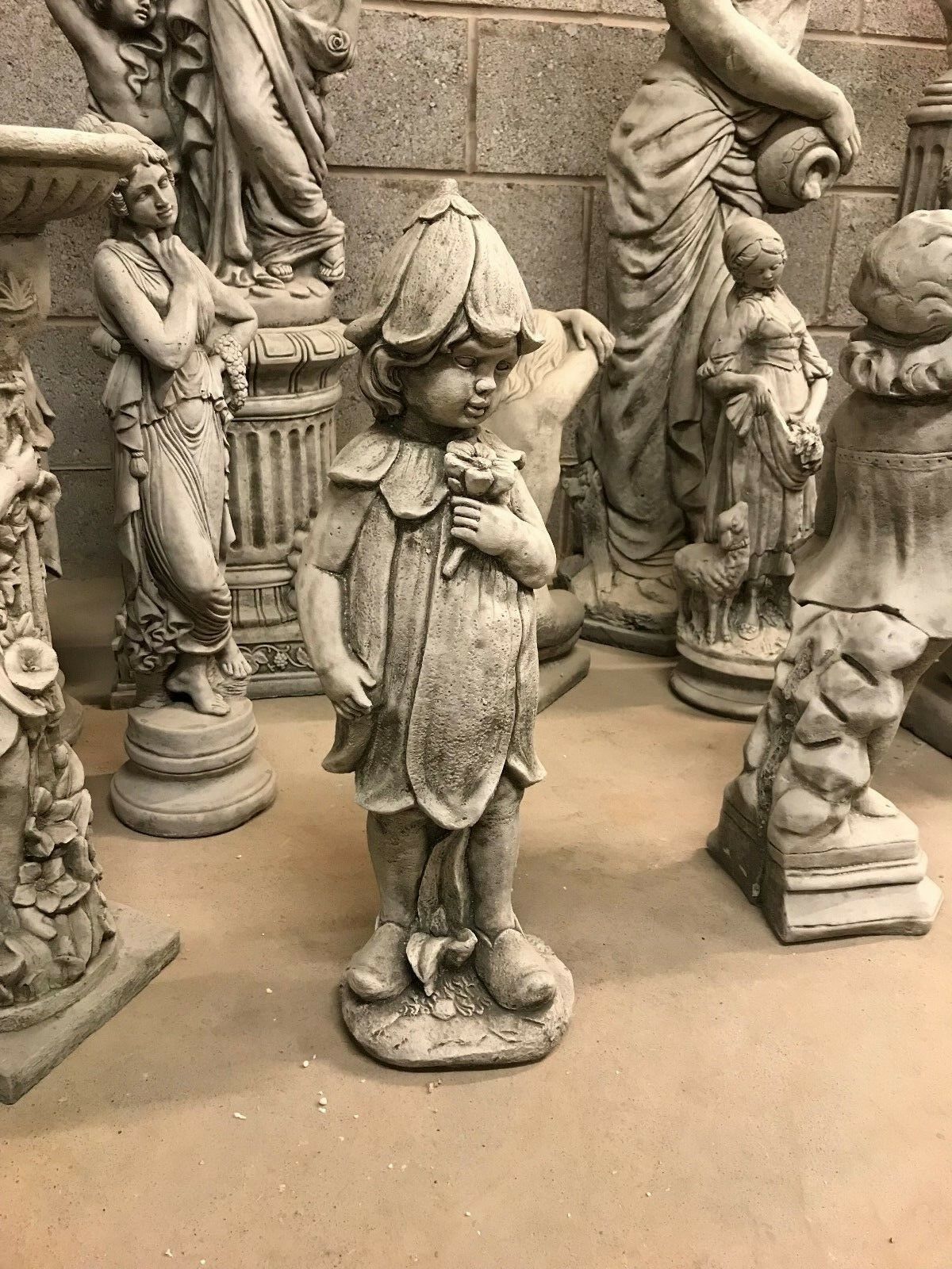 Elegant Stone Bluebell Girl Garden Statue with floral detailing, perfect for patios or flowerbeds. Handcrafted from solid limestone.
