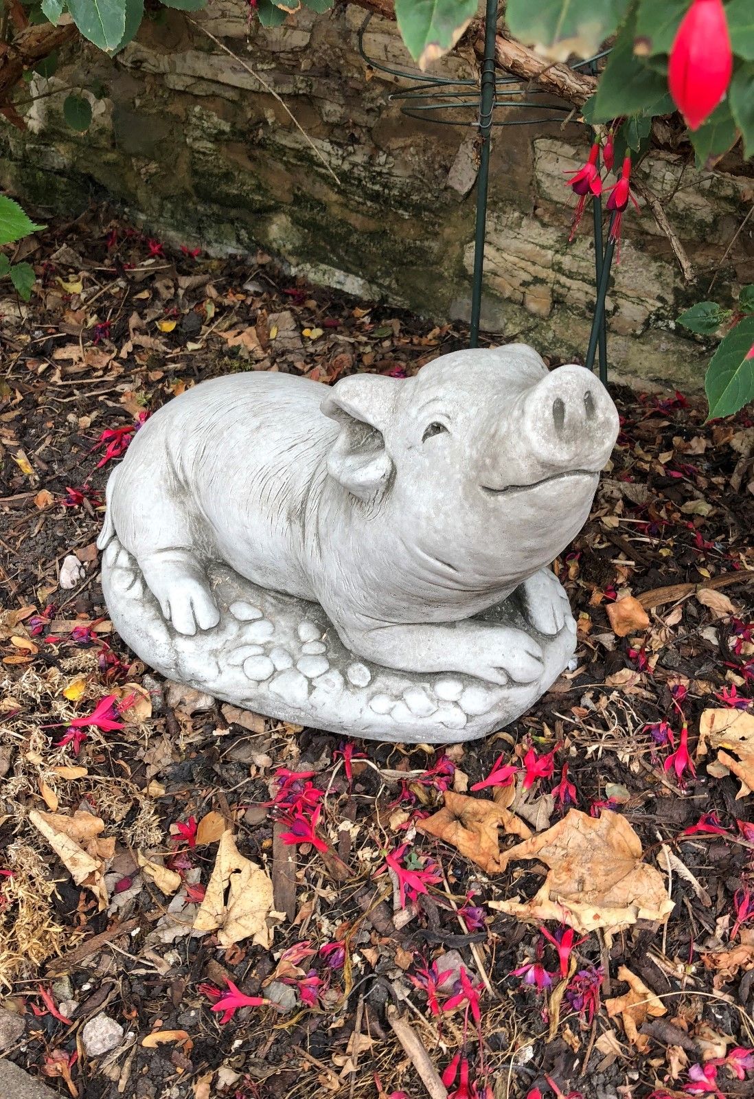 Chubby Stone Pig Sculpture Garden Ornament with a happy expression, perfect for enhancing garden decor. Heavy and weather-resistant limestone build.