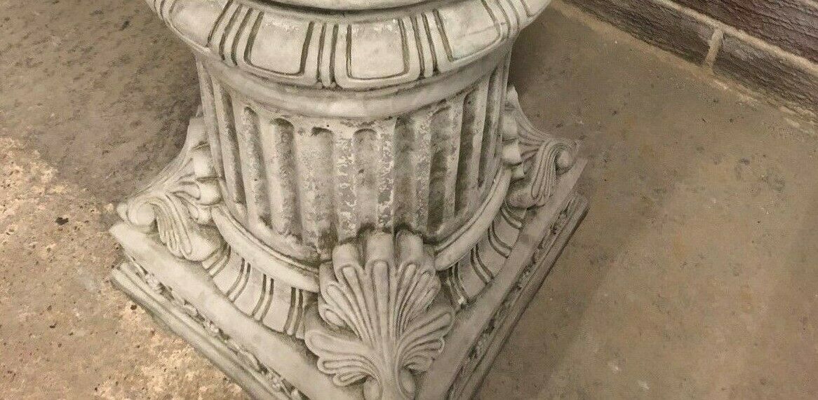 Top-down angle of a decorative limestone plinth with a central hole, designed for secure placement of garden ornaments or sculptures.