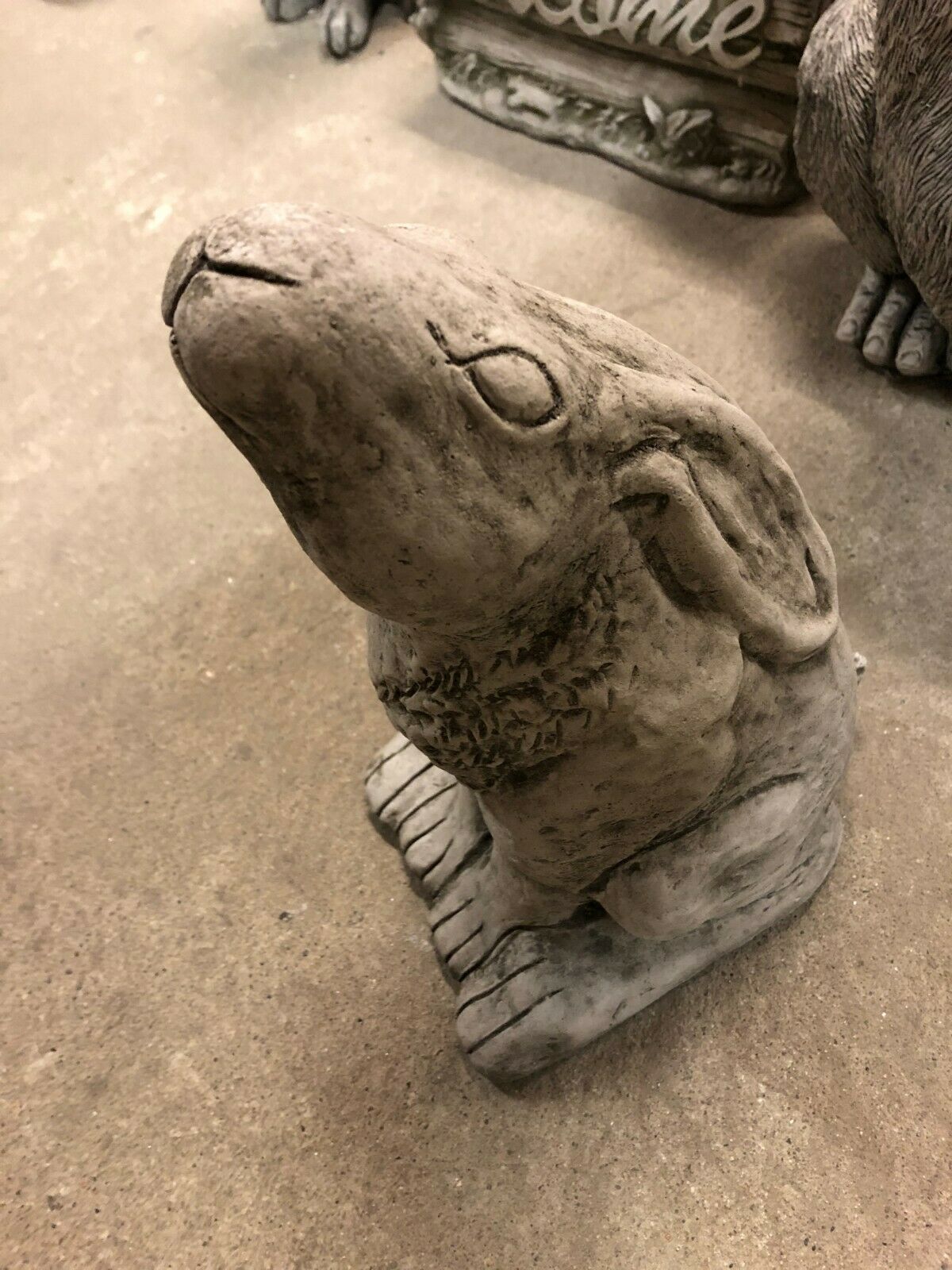 Close-up of the Moongazing Hare Stone Statue's face and upper body, featuring a weathered limestone look for rustic garden decor.