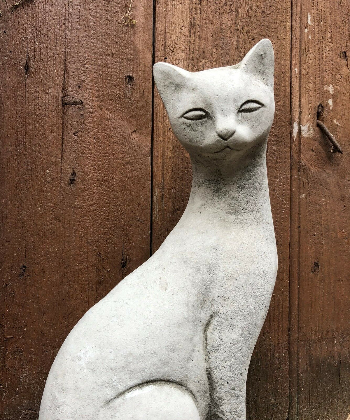 Detailed view of a stone Siamese cat statue with serene expression, suitable for garden or patio ornament use.