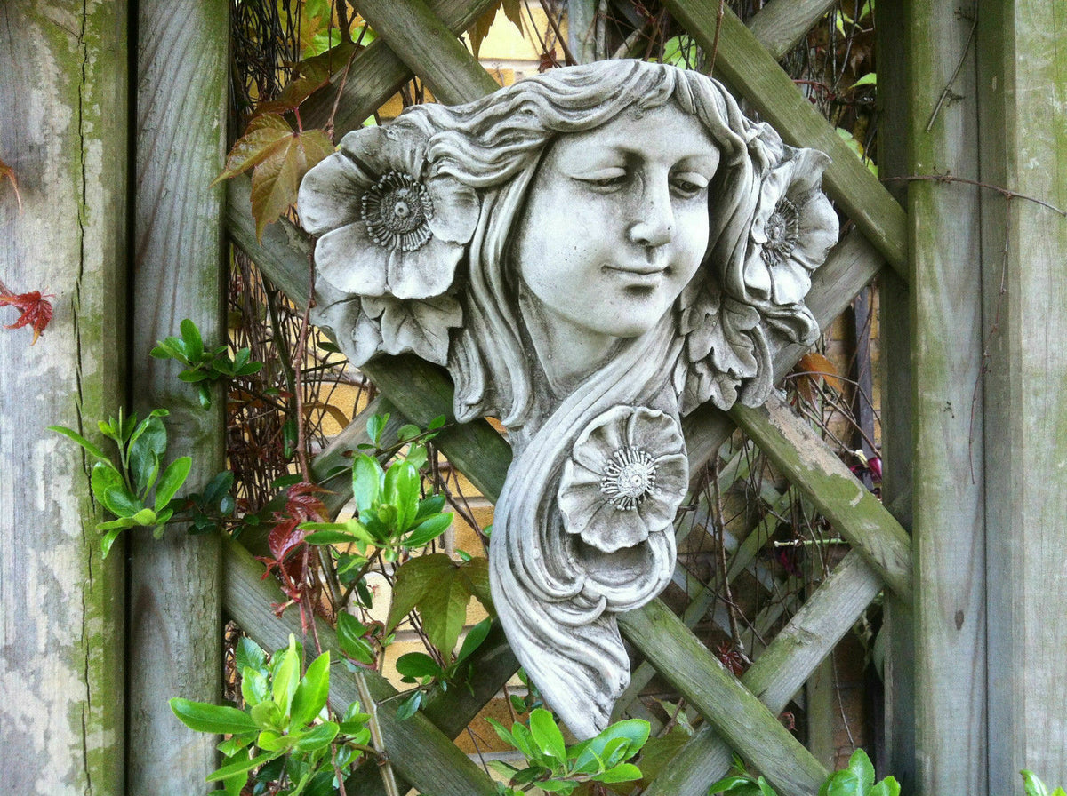 Decorative Art Nouveau Lady Garden Plaque with floral details on a lattice wall, ideal for outdoor wall decor in home gardens or patios.