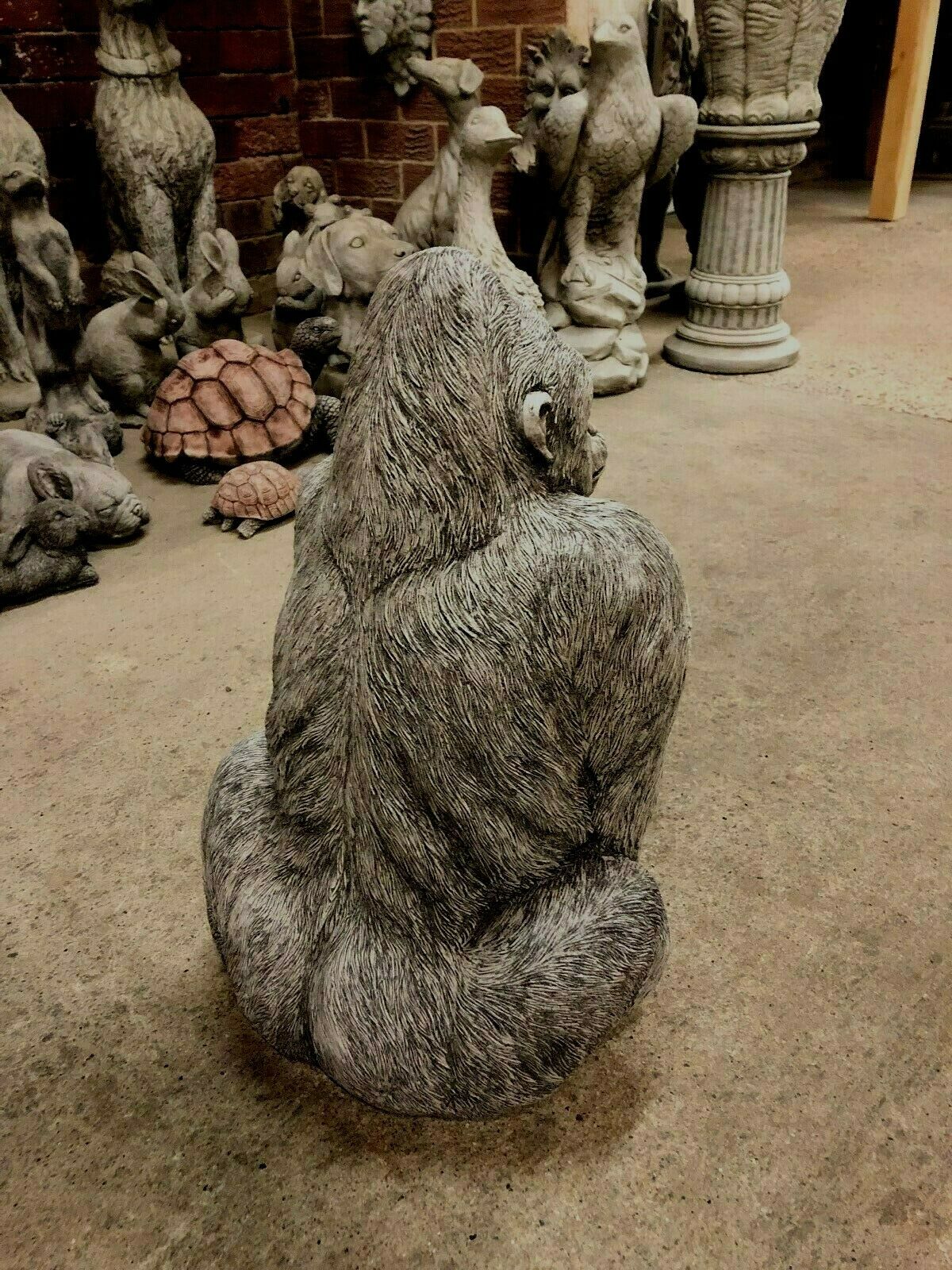 Rear angled view of Gorilla Statue - Stone Silverback Ornament, emphasizing durability and artistic detail for outdoor garden decor.