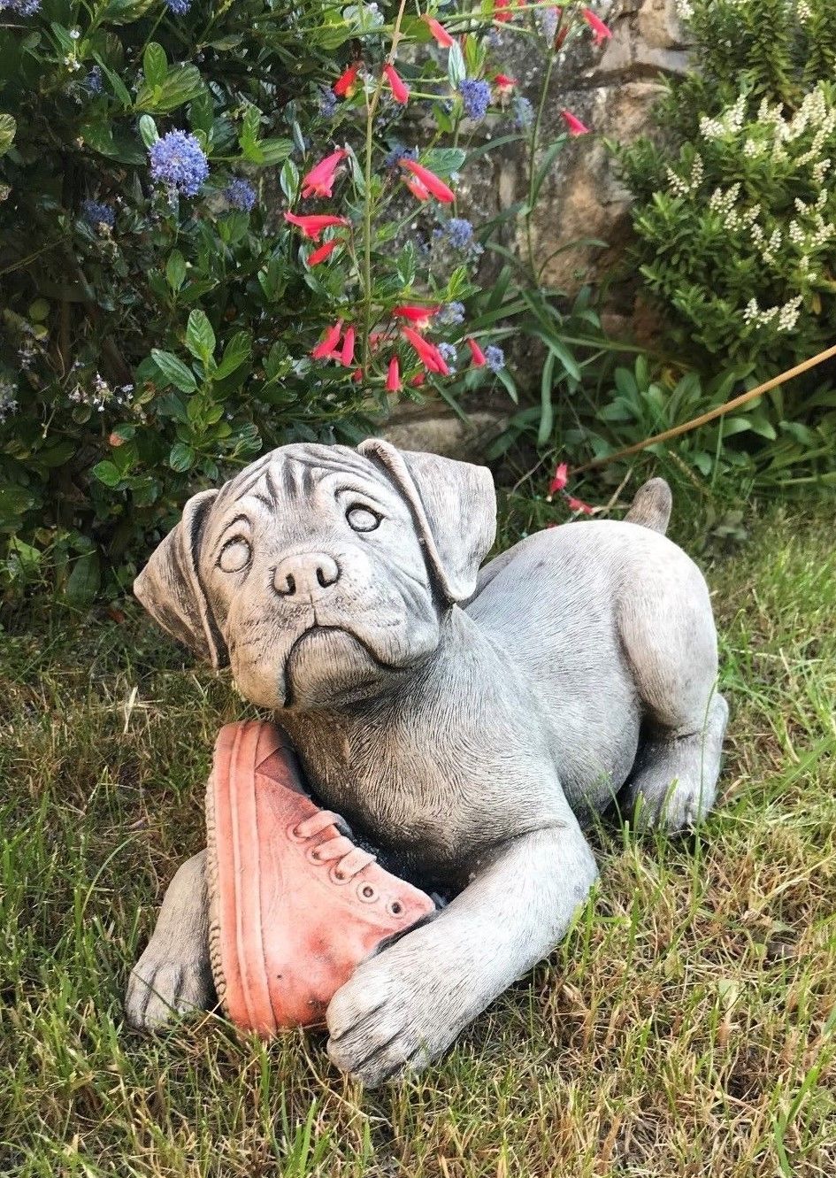 Boxer Puppy Ornament - Stone Sculpture of a playful puppy holding a red shoe, ideal for garden decoration and weatherproof outdoor charm.