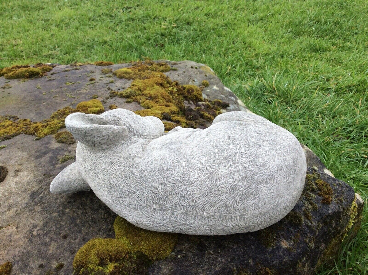Rear view of stone sleeping French Bulldog sculpture, highlighting textured stone finish for outdoor garden and patio use.