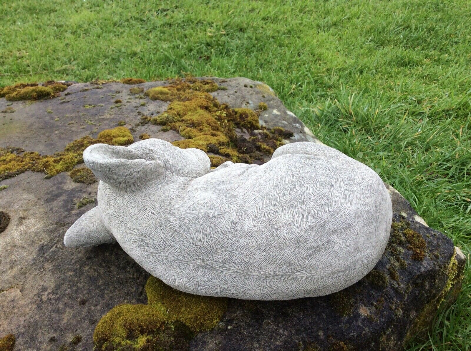 Rear view of stone sleeping French Bulldog sculpture, highlighting textured stone finish for outdoor garden and patio use.
