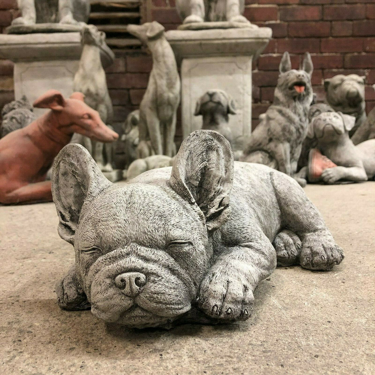 Stone Sleeping French Bulldog Garden Ornament with closed eyes and detailed texture, perfect for lawn or flowerbed decoration.