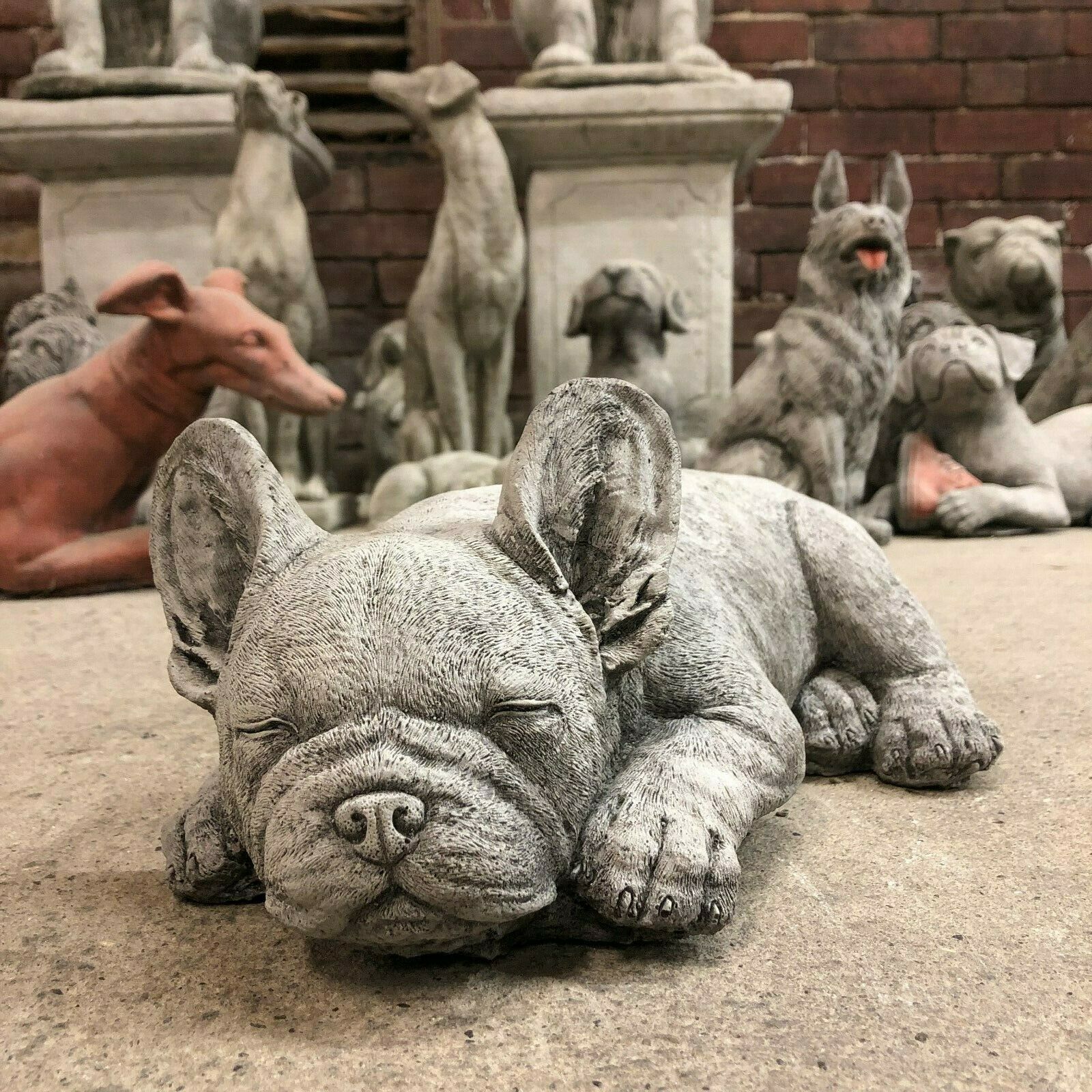 Stone Sleeping French Bulldog Garden Ornament with closed eyes and detailed texture, perfect for lawn or flowerbed decoration.