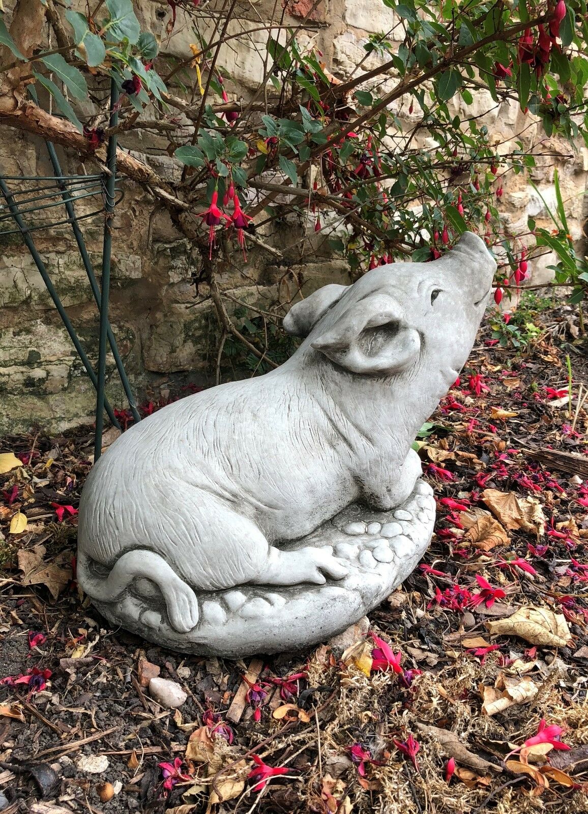 Side view of the Stone Pig Sculpture Garden Ornament with curled tail and lifelike features. A stunning addition to farm-style or rustic garden themes.