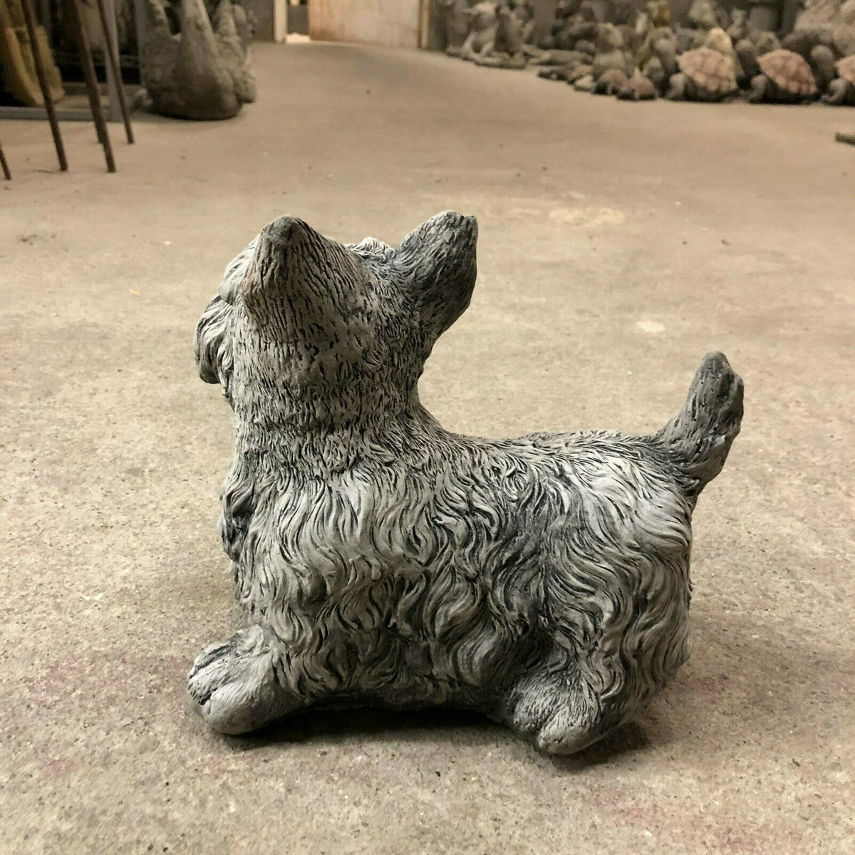 Side-back angle of Scottish Terrier garden statue in stone finish, showcasing realistic fur design for outdoor decor.