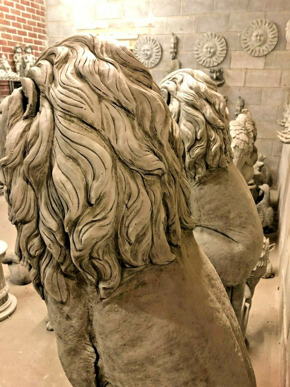 Rear view of lion statues highlighting detailed mane carvings and robust stone structure, ideal for luxury garden installations.