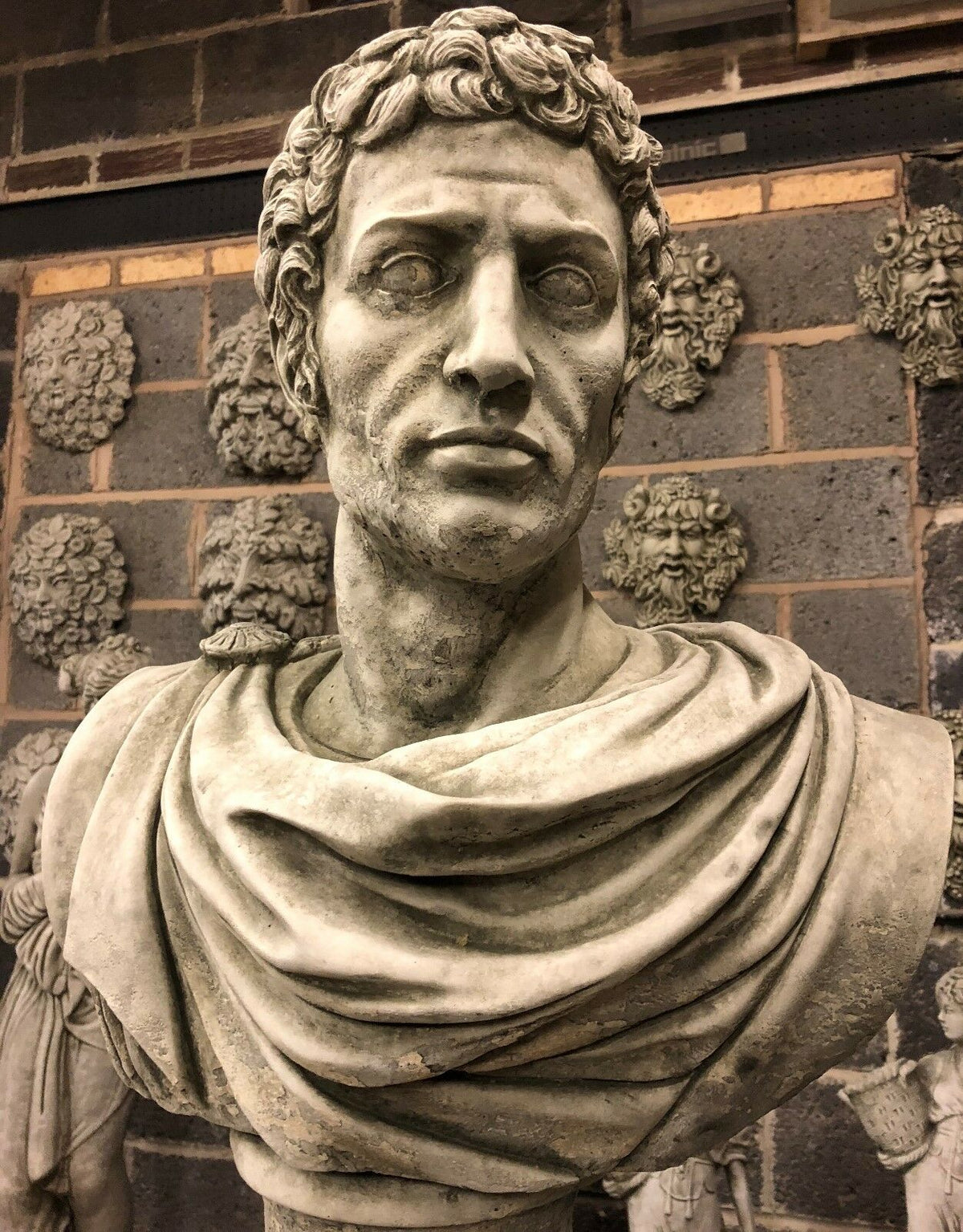 Detailed front close-up of Stone Marc Anthony Bust Statue, capturing expressive Roman features and limestone texture for garden ornamentation.
