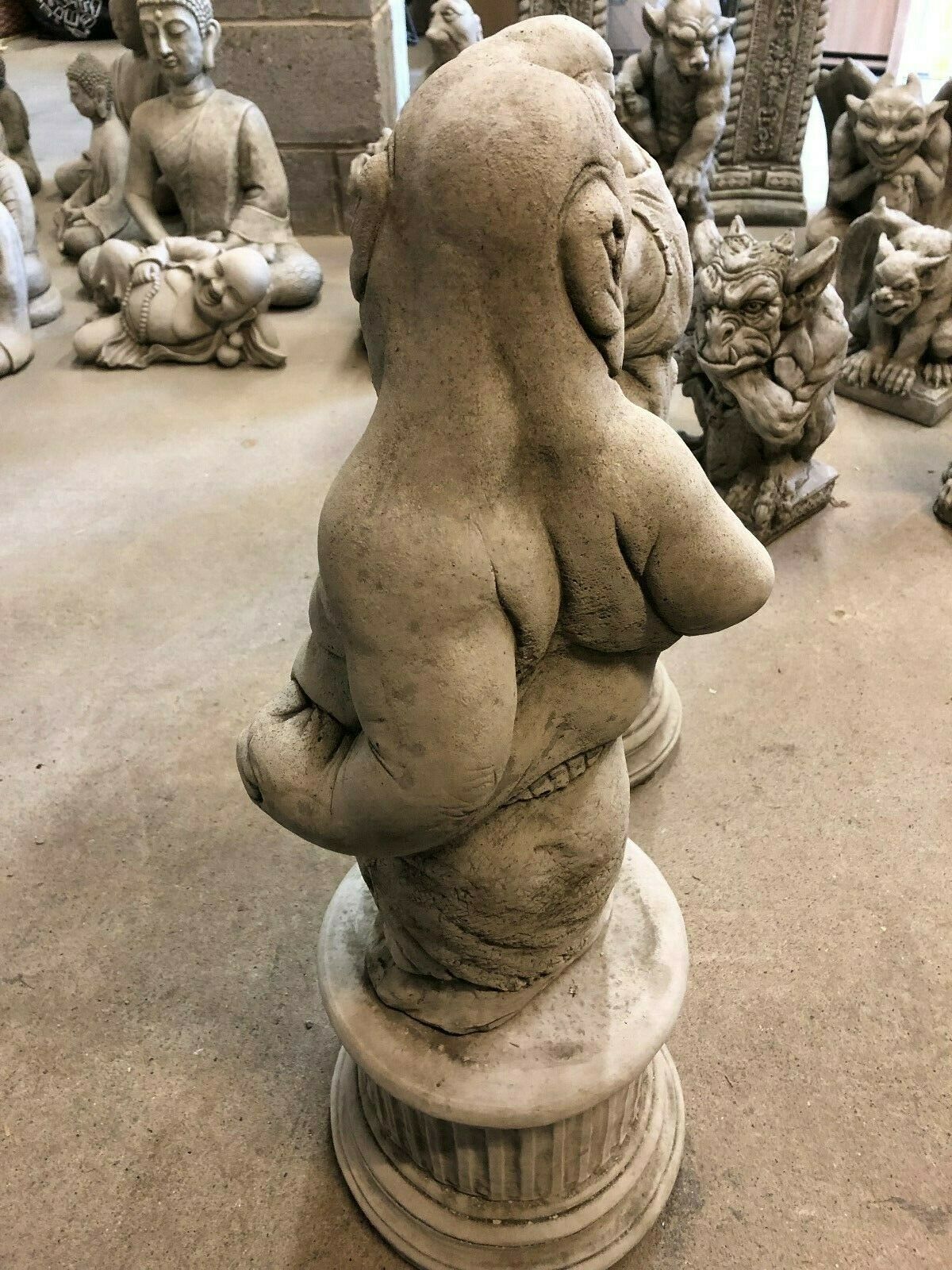 Back view of stone garden ornament showing whimsical boxer with hands behind back, from Bare Knuckle Boxer Statues collection.