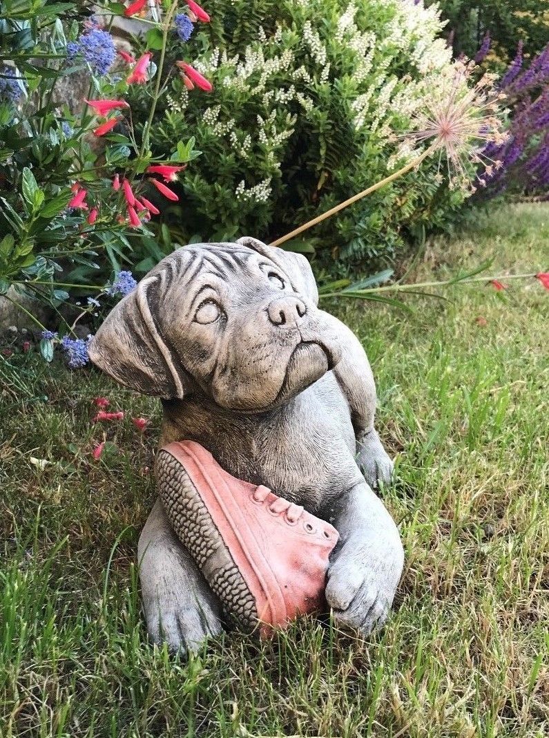 Durable Boxer Puppy Garden Sculpture with detailed stone texture, featuring a cute puppy clutching a red shoe, perfect for patios and lawns.