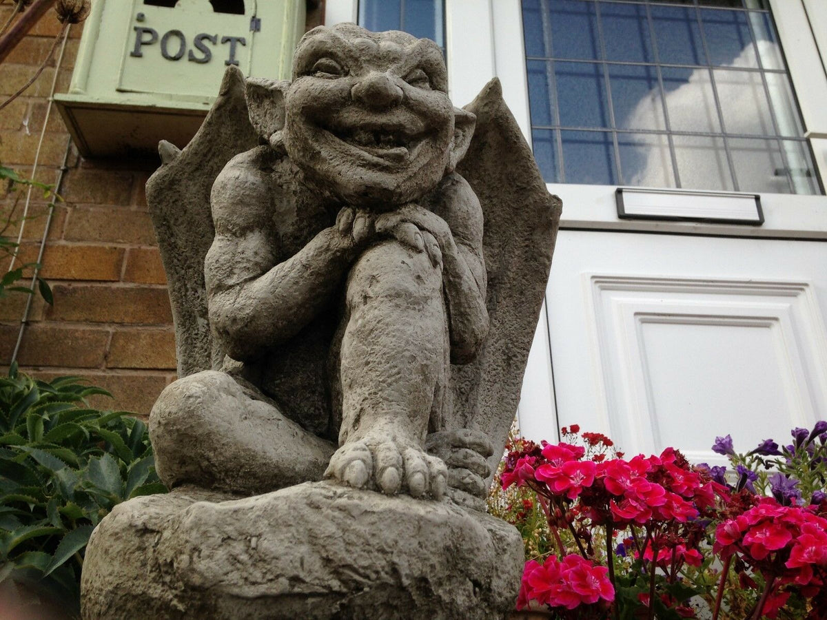 Close-up of Winged Gargoyle Garden Ornament with detailed facial expression and stone finish, enhancing gothic charm in a home garden setting.
