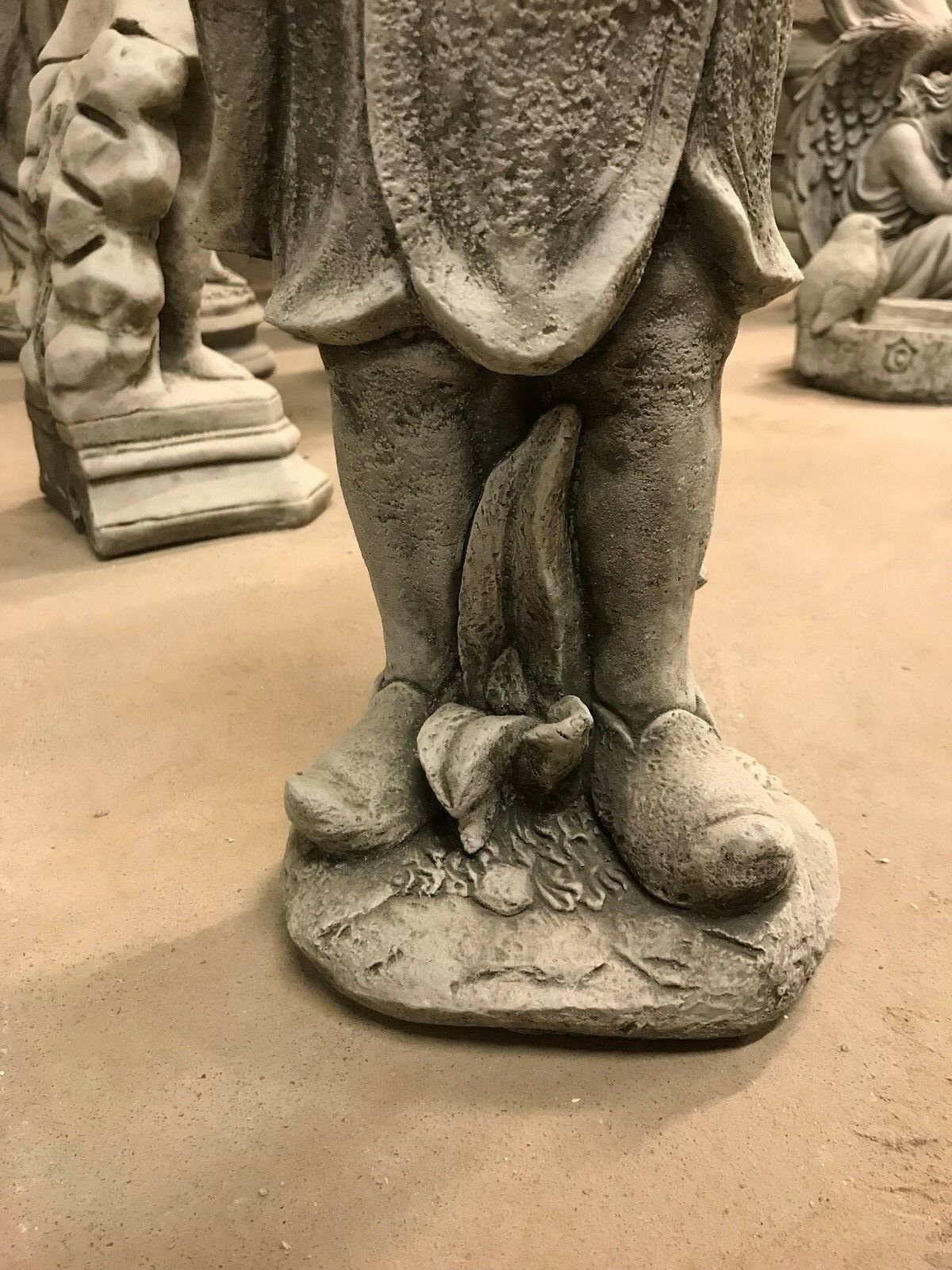 Base of the Stone Bluebell Girl Statue with flower accents, designed for stable placement in lawns or garden paths.