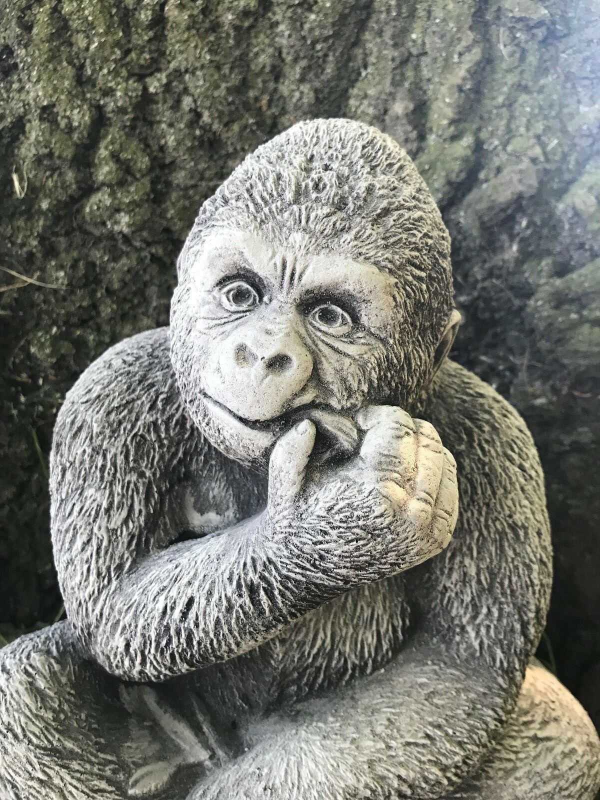 Close-up of antique grey stone gorilla ornament showing detailed facial features and texture, perfect for garden sculpture collections.