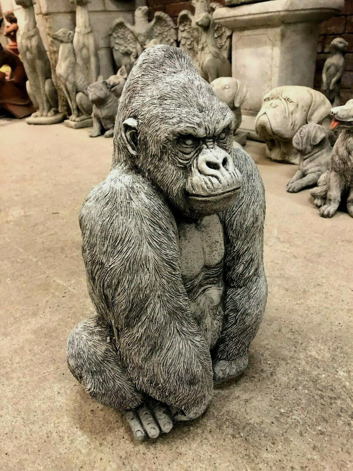 Three-quarter front view of Gorilla Statue with limestone finish, showing expressive face and detailed body for garden ornament use.