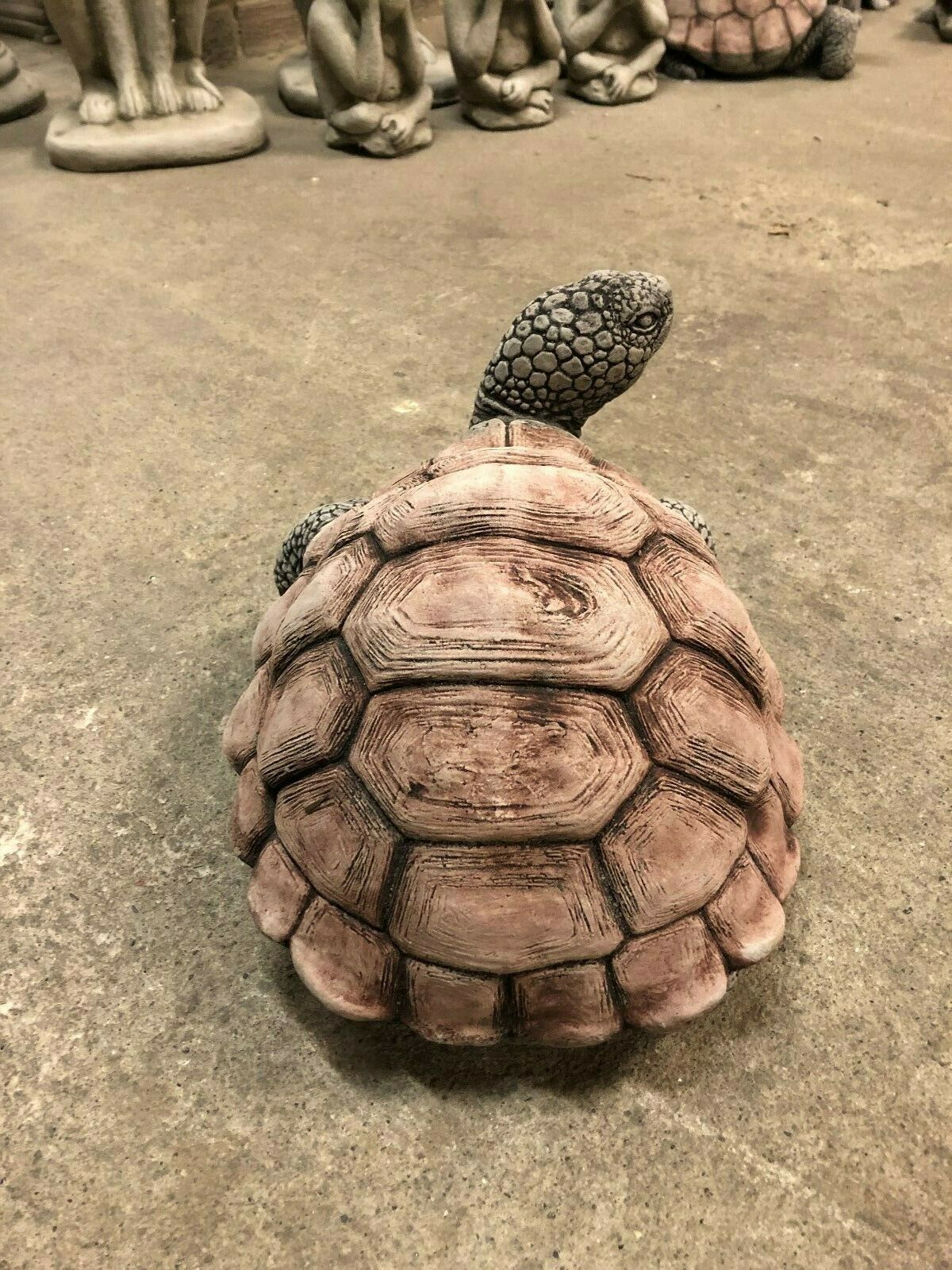 Top-down view of large tortoise garden statue with antique stone finish. Durable and decorative for lawns and patios.