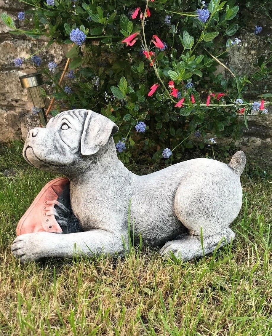 Weatherproof Boxer Puppy Ornament in stone, showing side profile of a puppy lying down with a red shoe, great for garden animal decor.