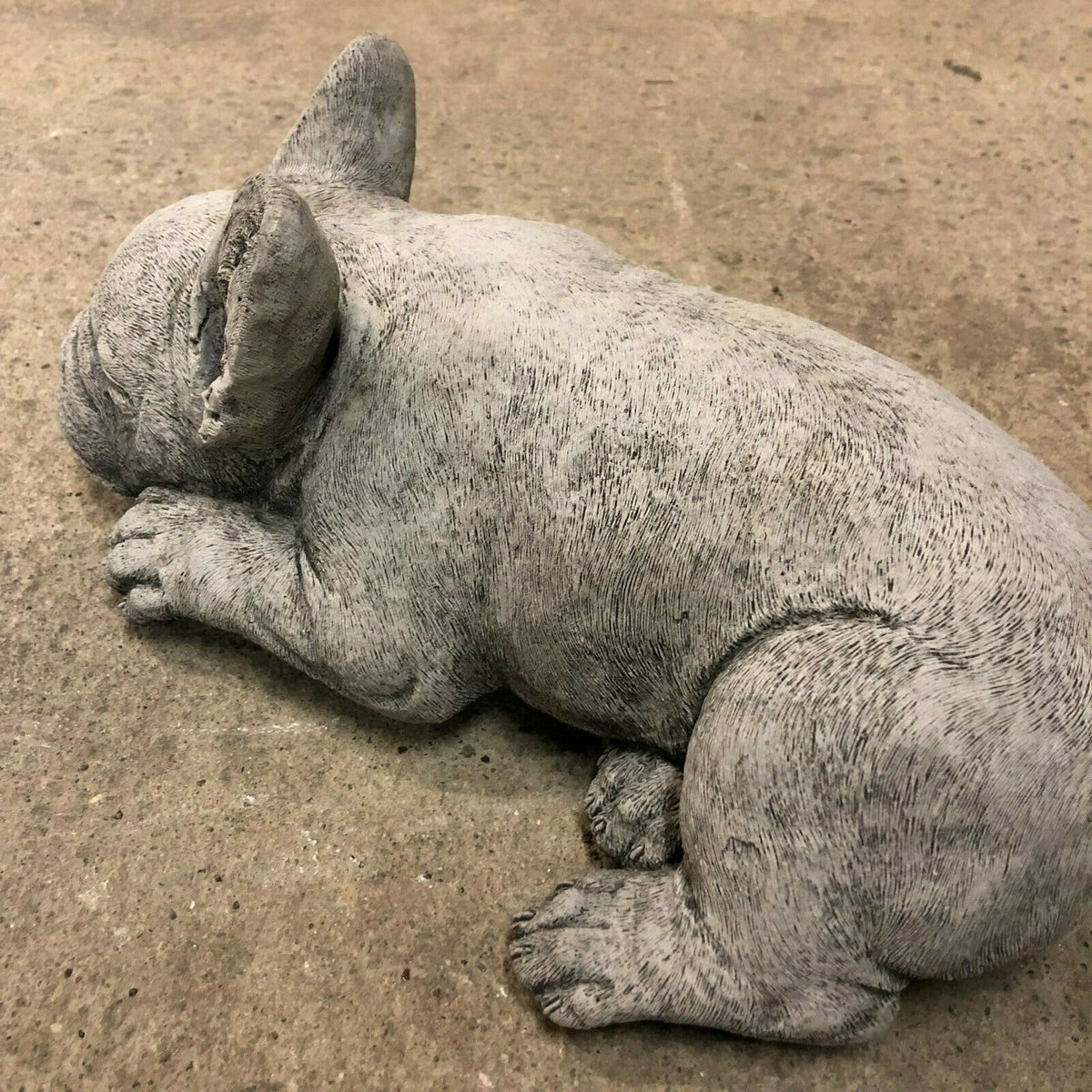 Side view of handcrafted Stone Sleeping French Bulldog Garden Ornament showing realistic fur texture and relaxed posture.
