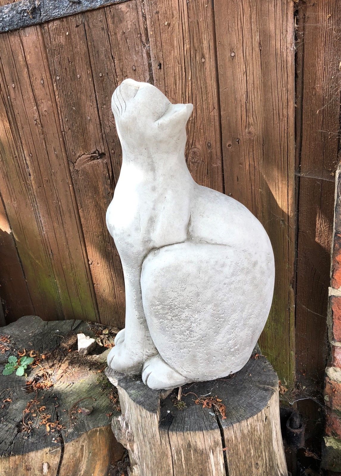 Side profile of Stone Cat Garden Ornament - Durable Stone, highlighting smooth limestone texture and elegant sitting posture.