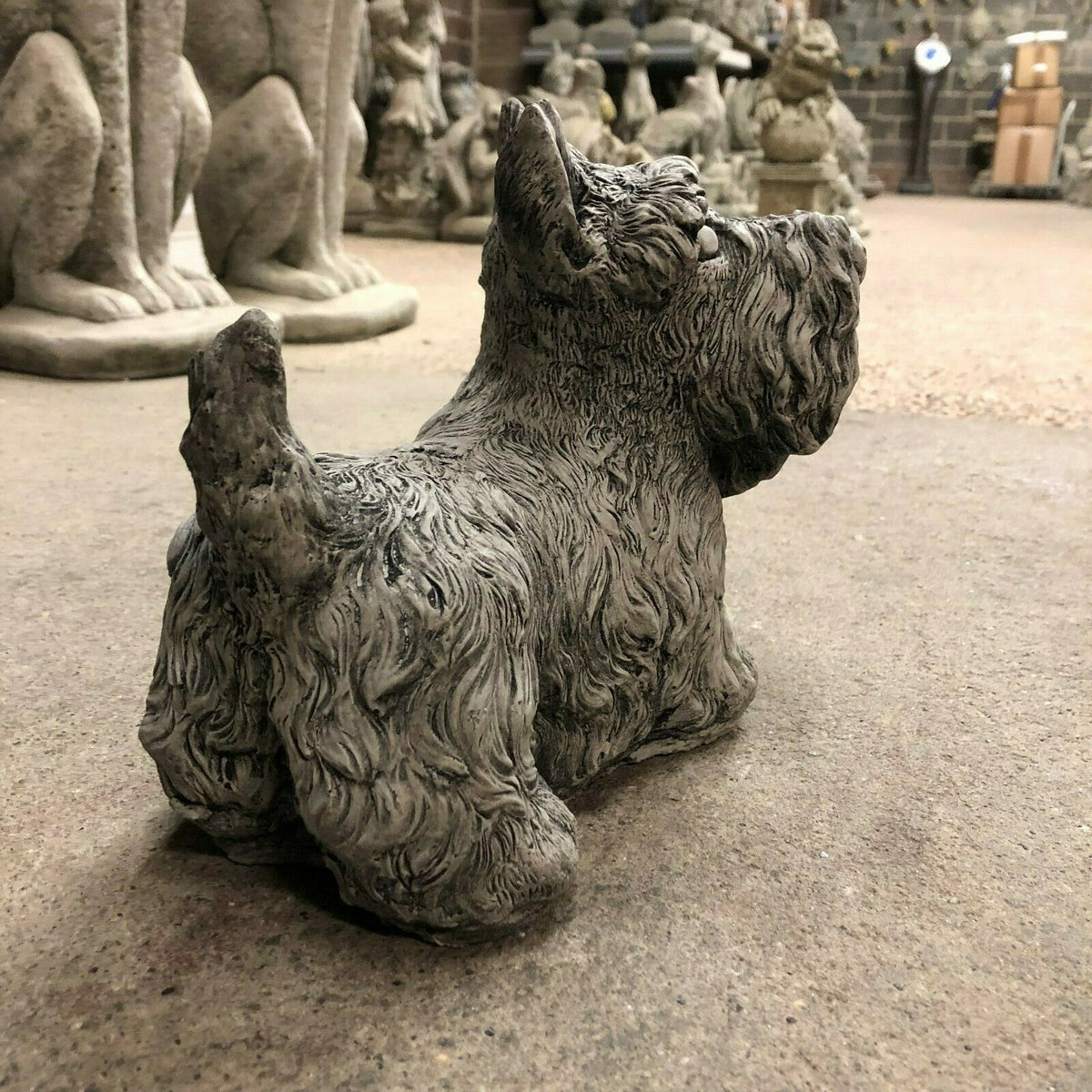 Backside view of Scottish Terrier garden statue in antique grey stone, highlighting craftsmanship and durable limestone material.