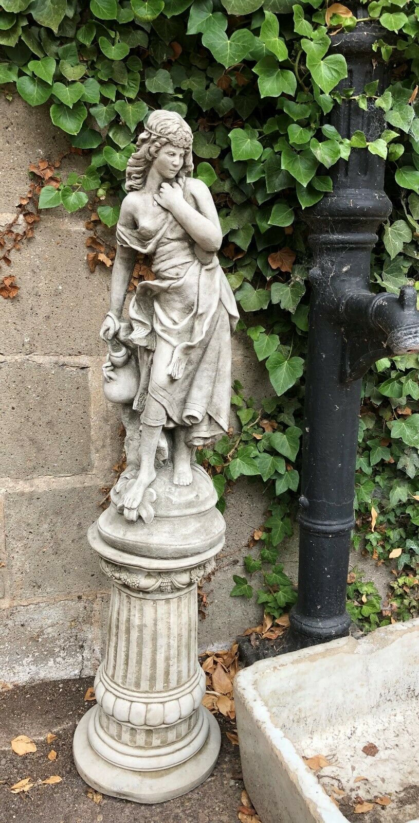 Elegant Jug Lady on Plinth garden statue with detailed limestone craftsmanship, perfect for enhancing patio or flowerbed aesthetics.