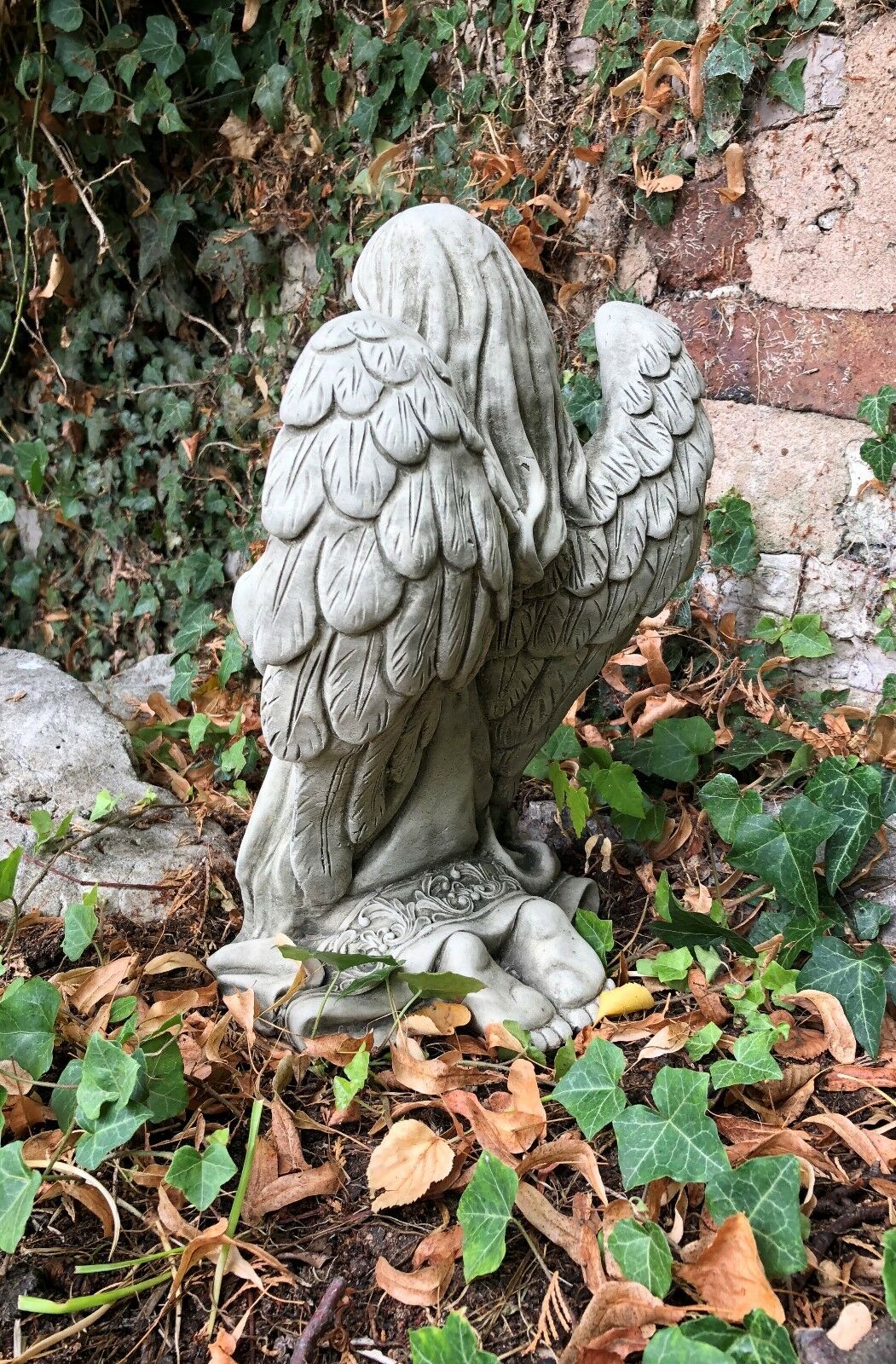 Rear angle of Stone Praying Angel Statue highlighting textured wings and flowing hair, durable for outdoor garden settings.