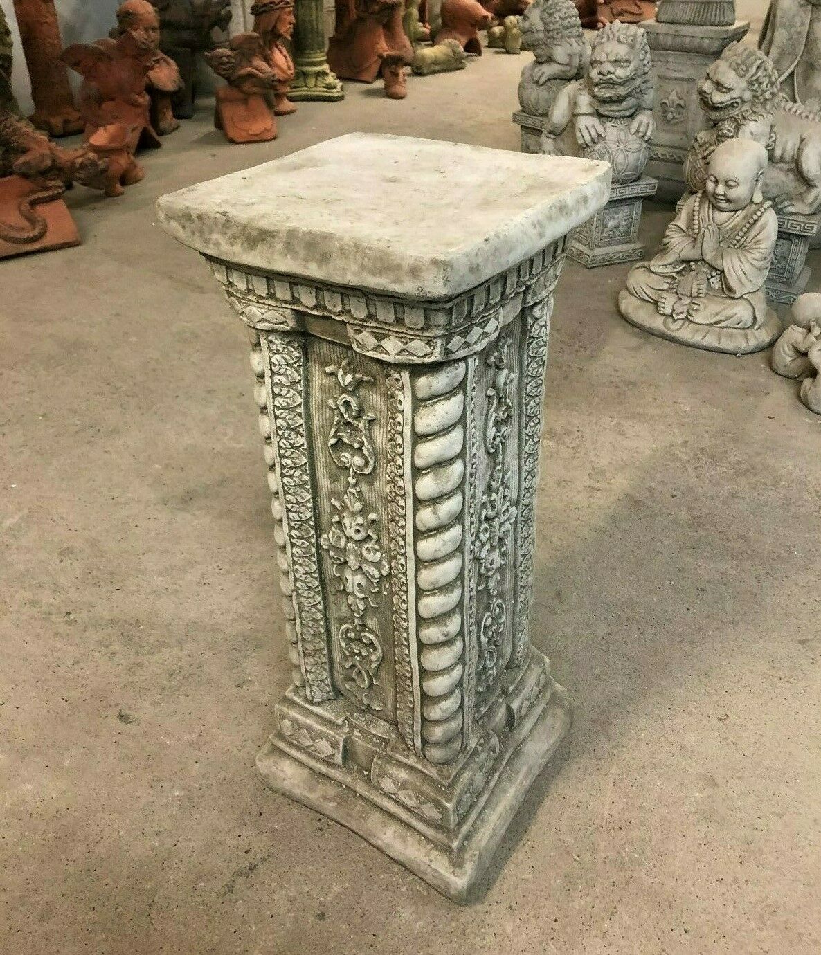 Stone garden column with antique finish, tall square plinth ideal for outdoor ornament display. Features ornate detailing and weather-resistant limestone.