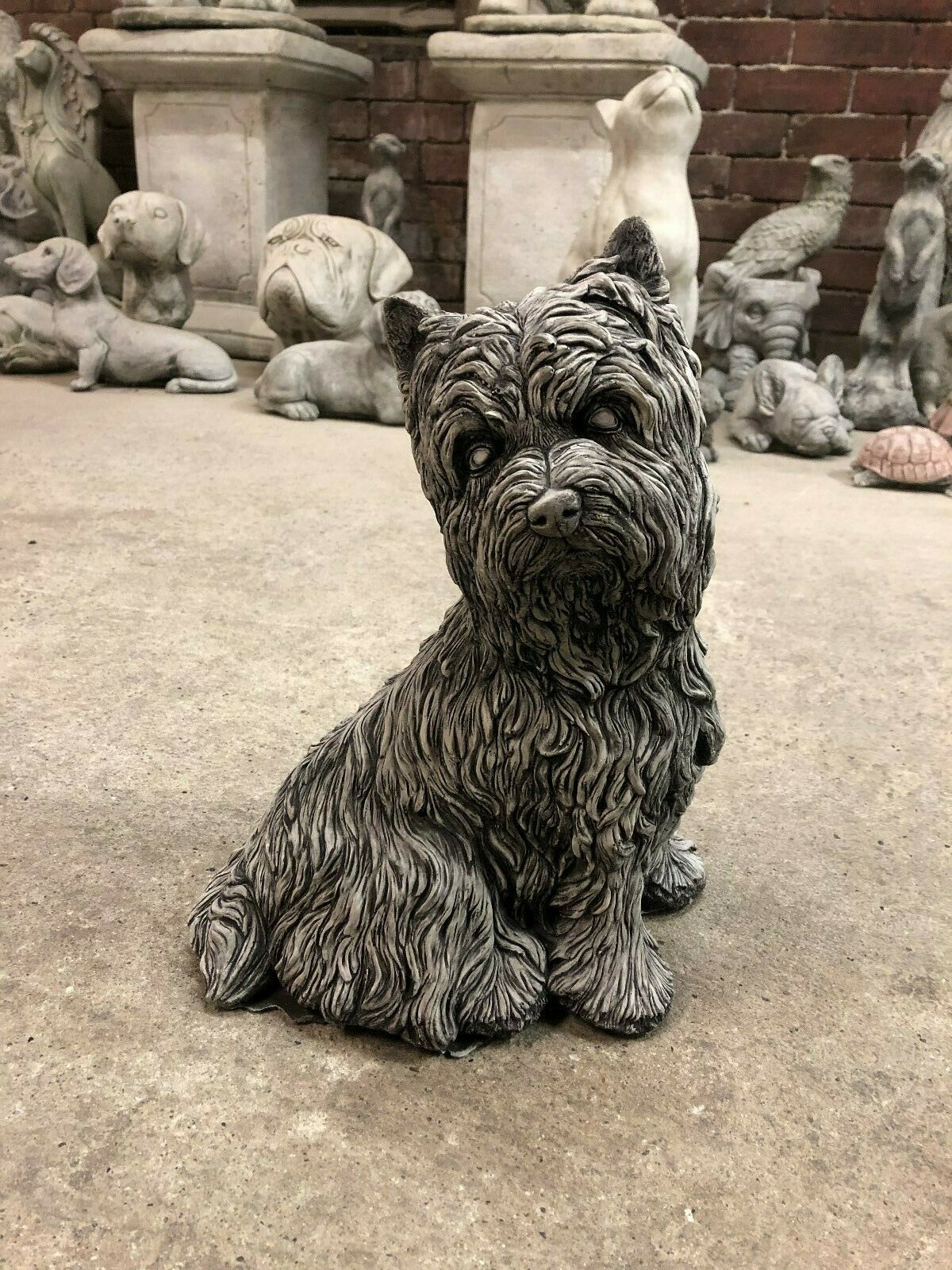 Stone Westie Dog Statue for garden or patio, featuring lifelike fur texture and seated pose. Perfect lawn ornament with free UK delivery.