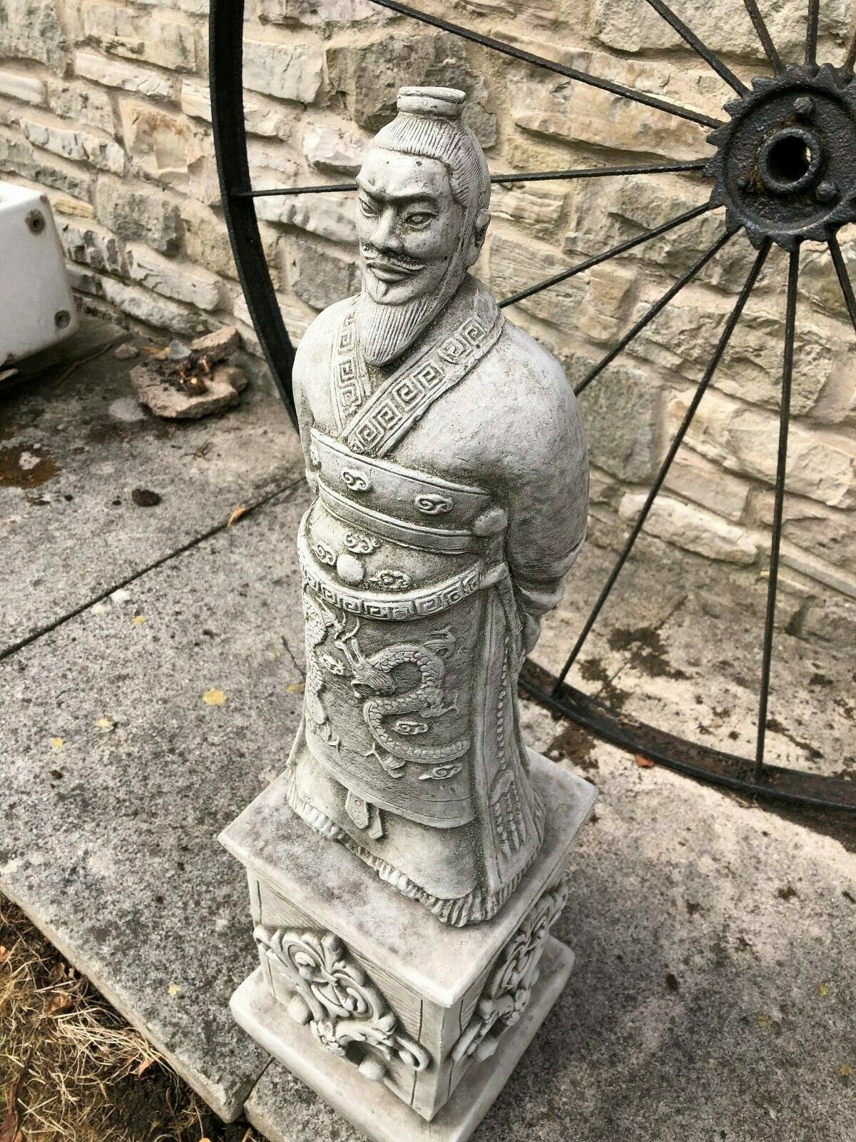 Top-down view of the Stunning Stone Zhan Shi Warrior Garden Plinth Statue, capturing the full figure and decorative base in a garden setting.