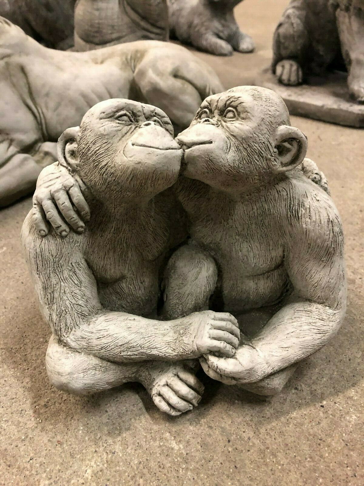 Close-up of limestone Kissing Monkey Couple Garden Ornament, perfect for adding love and charm to garden sculptures.