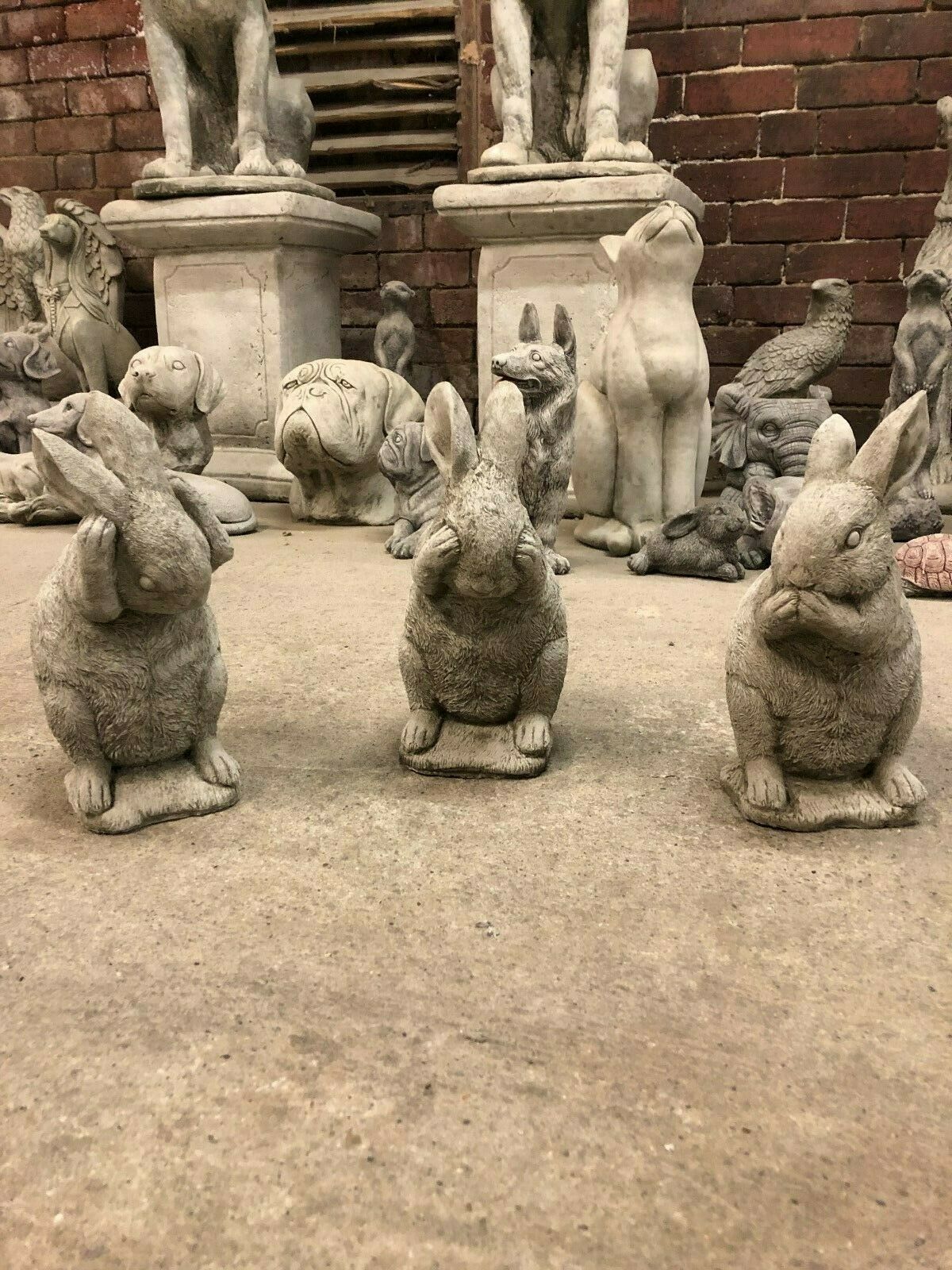 Handmade stone rabbit statues in Hear, See, Speak No Evil design, perfect for adding charm to garden or patio spaces.