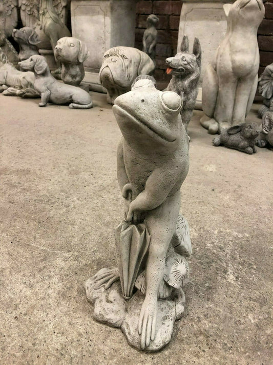 Stone Frog Garden Ornament - Elegant with Umbrella | Fine Finish, displayed indoors among other animal sculptures, ideal for garden decor.
