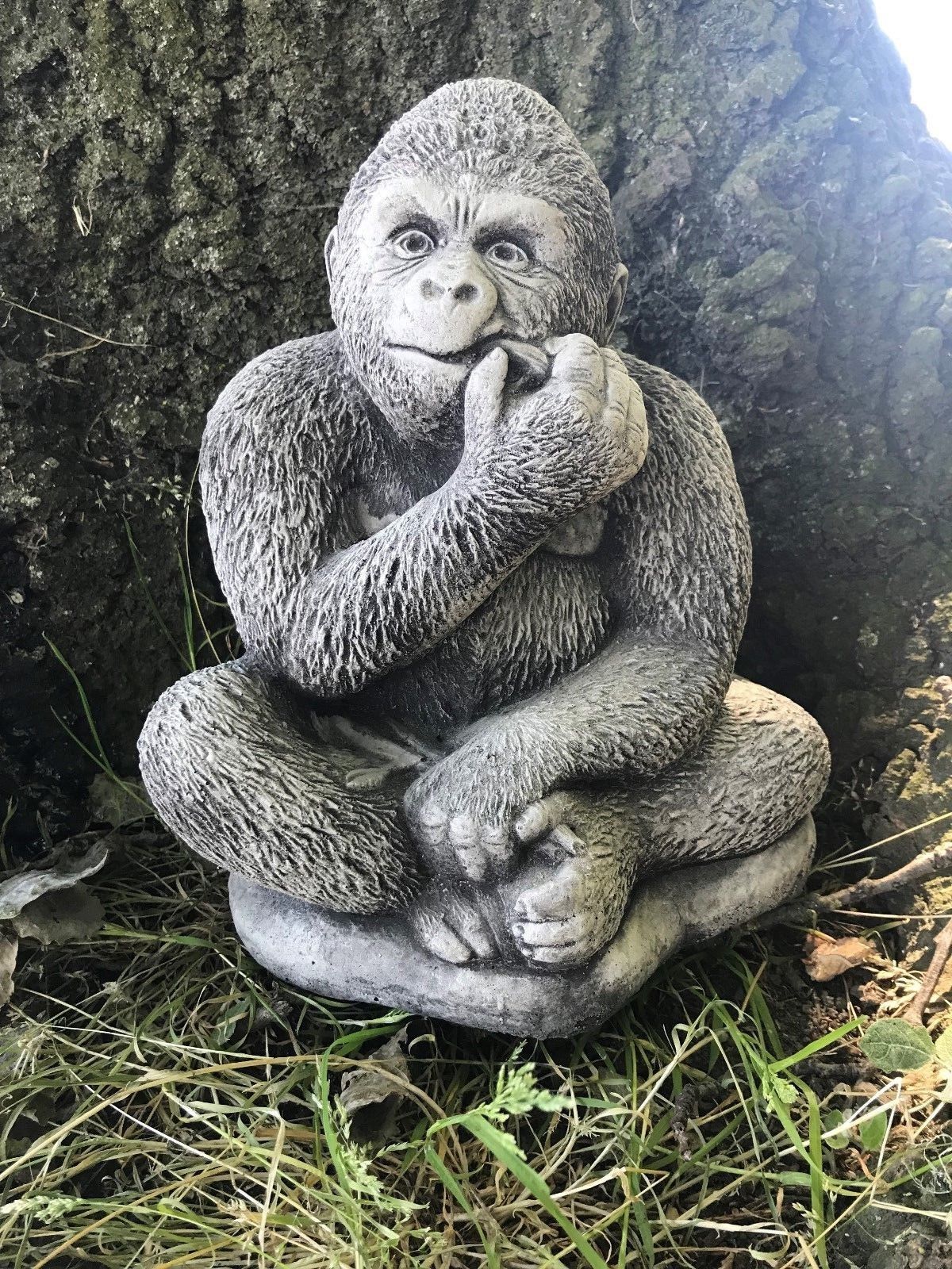 Front-facing stone gorilla garden sculpture with antique grey finish, ideal for adding character to lawn or garden spaces.
