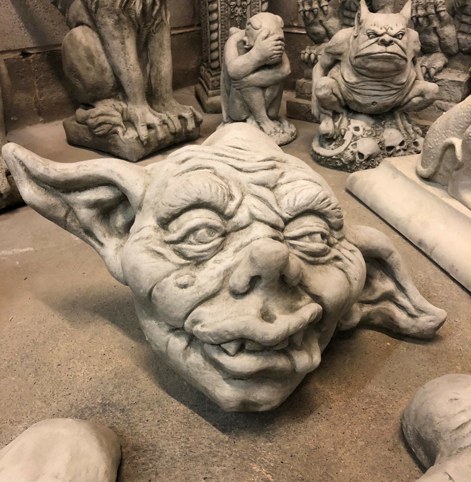 Stone Zombie Set Ornaments - Garden Decor|Limestone, Weatherproof. Close-up of zombie head sculpture with wrinkled features and pointed ears.
