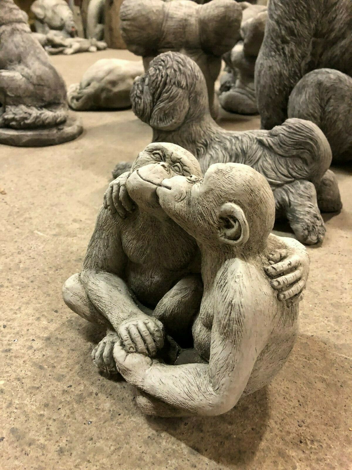 Side view of Garden Stone Monkey Ornament - Kissing Couple, showing detailed craftsmanship for outdoor decor.