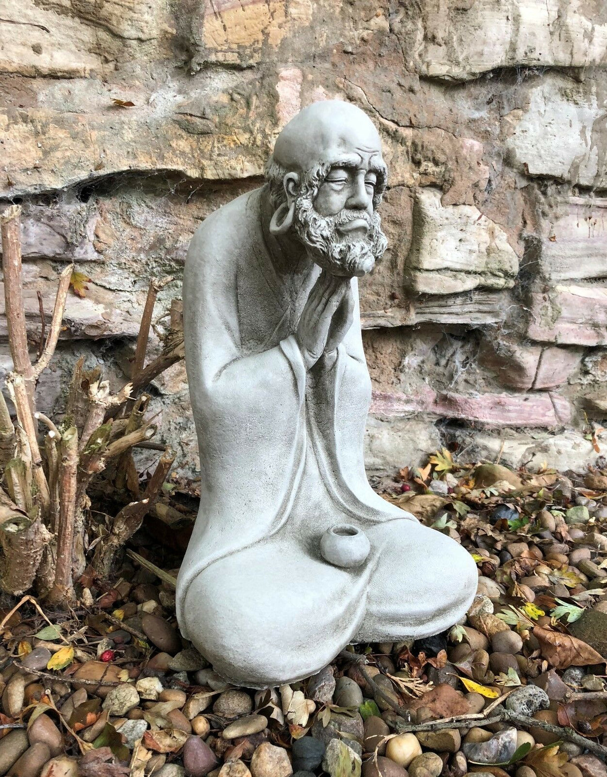 Angled view of the Stunning Stone Praying Old Monk Sculpture Garden Ornament, perfect for adding spiritual charm to patios or garden spaces.