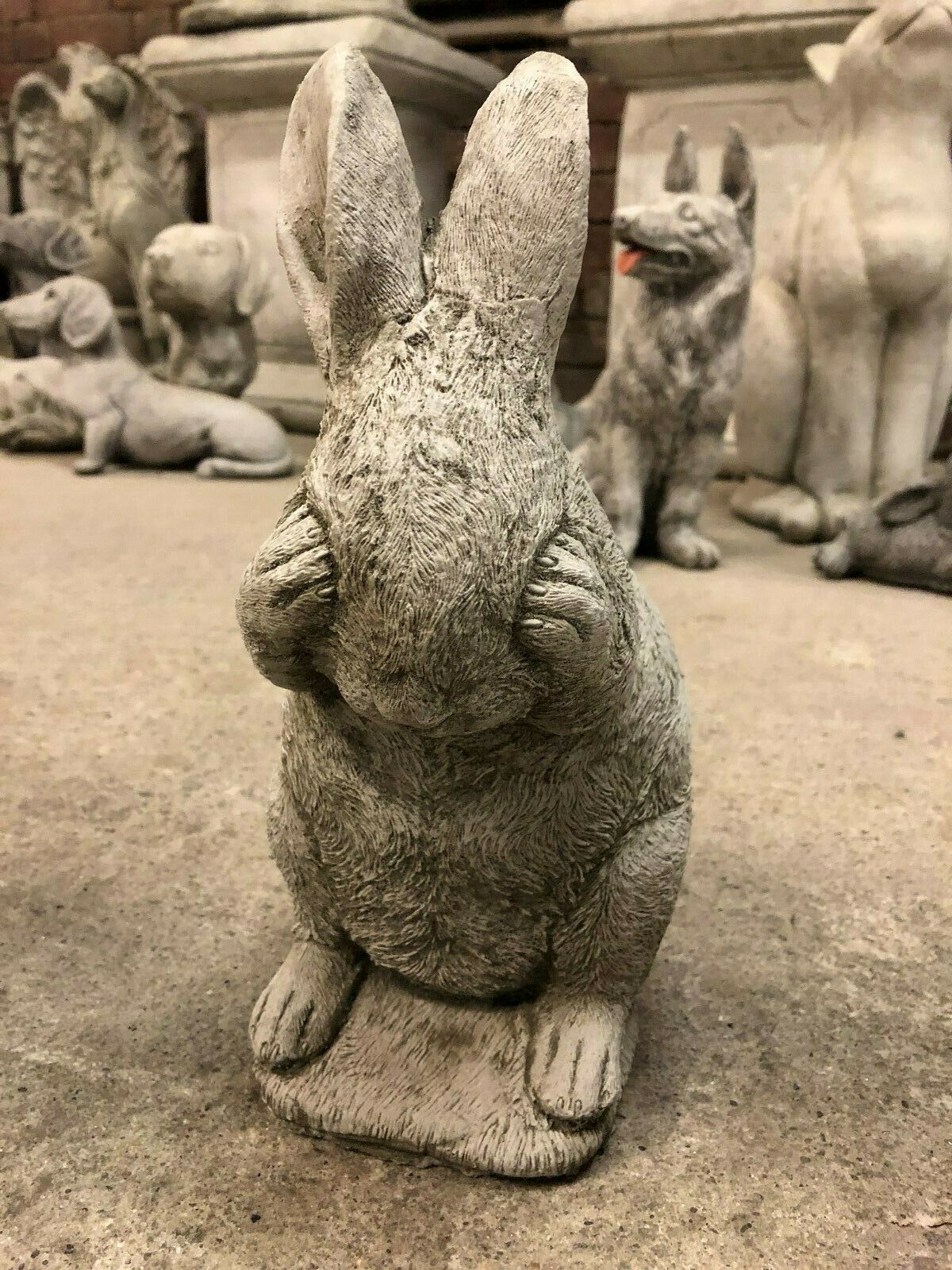 Close-up of See No Evil rabbit statue with paws covering eyes, part of the Rabbit Trio garden ornament set in antique stone finish.