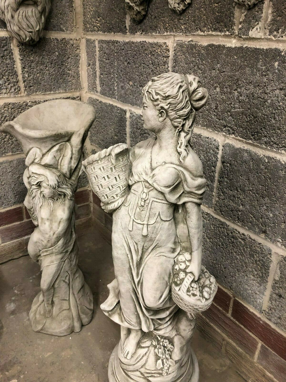 Close-up of Stone Roman Lady Garden Statue holding baskets, showcasing detailed limestone craftsmanship for elegant garden decoration.