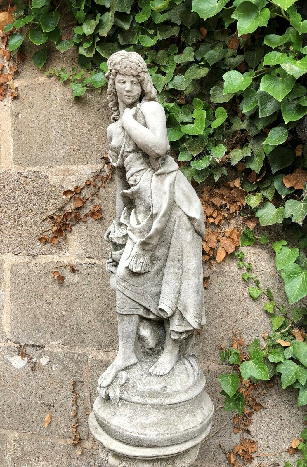 Rear angle of limestone Garden Stone Statue - Jug Lady Plinth, highlighting sculpted textures and graceful posture for garden ornamentation.
