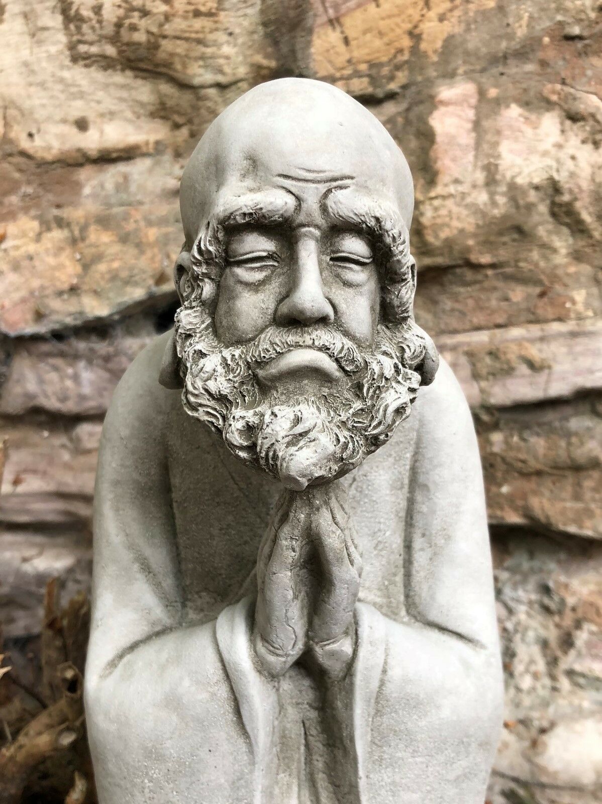 Close-up of the Stunning Stone Praying Old Monk Sculpture Garden Ornament highlighting the intricate facial features and meditative expression.